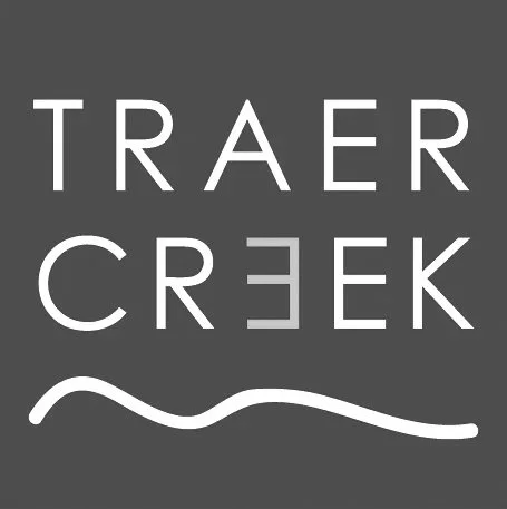 Logo for Traer Creek with stylized mountain outline.