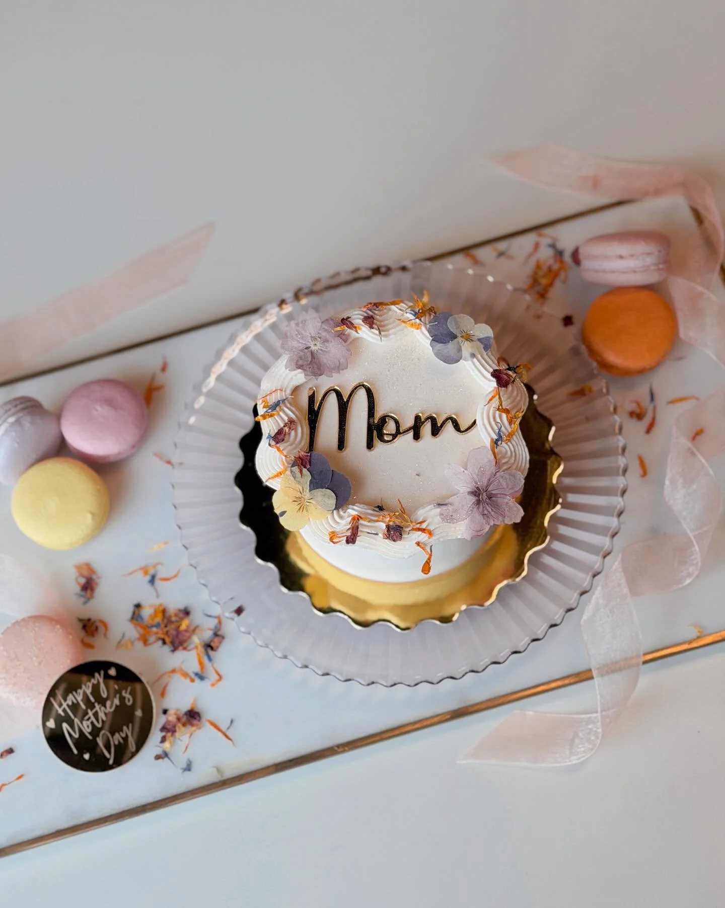 Mother&rsquo;s Day mini cakes are back with a new design! This year&rsquo;s cake features edible dried flowers and the gold acrylic topper of your choice. 

Cake not Mom&rsquo;s thing? We&rsquo;ve got you covered with a sweet charcuterie box or macar