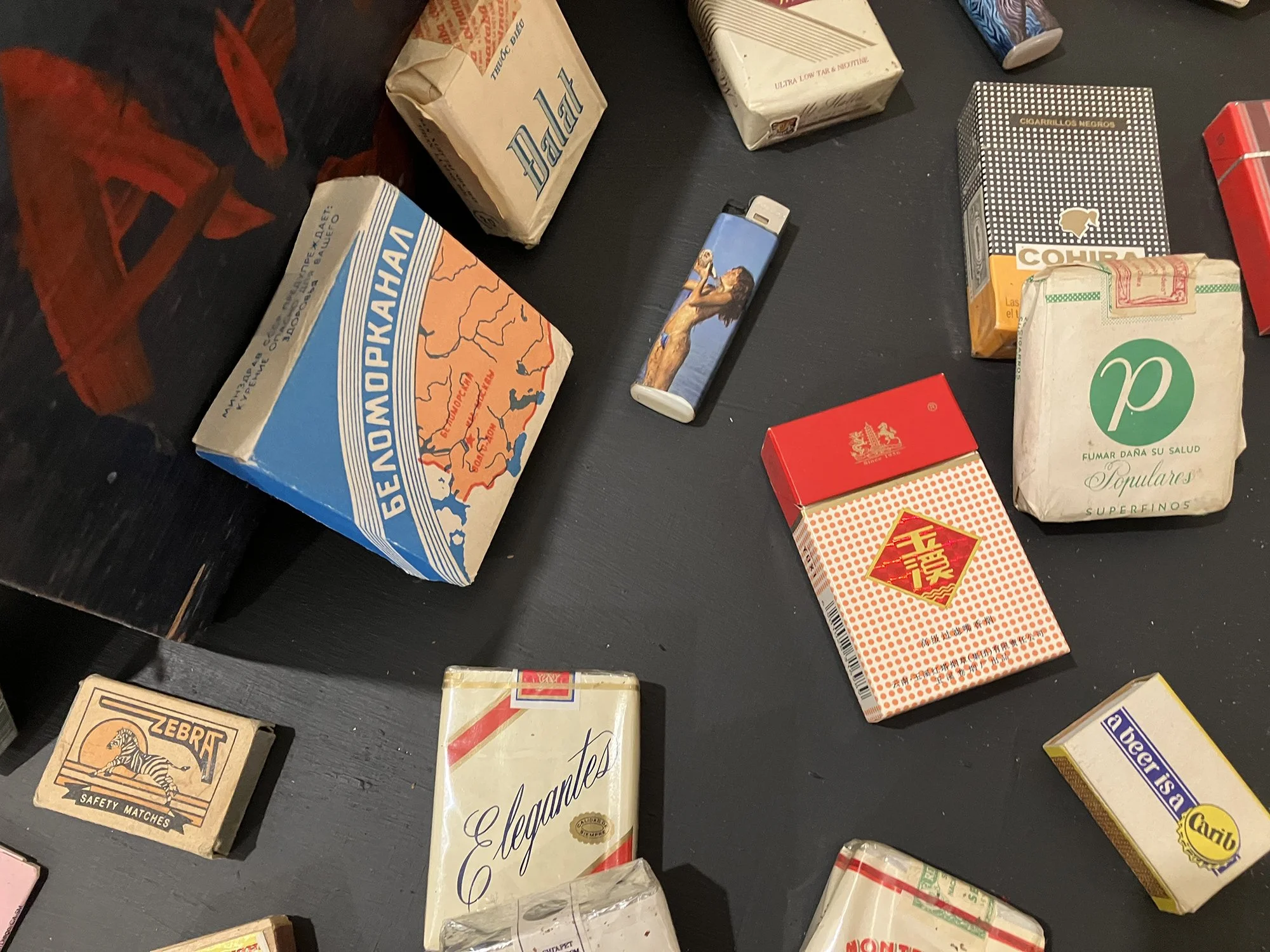 Assorted empty and unopened cigarette packs and other smoking paraphernalia 1965-, cardboard, ink, wood, metal, plastic, various dimensions