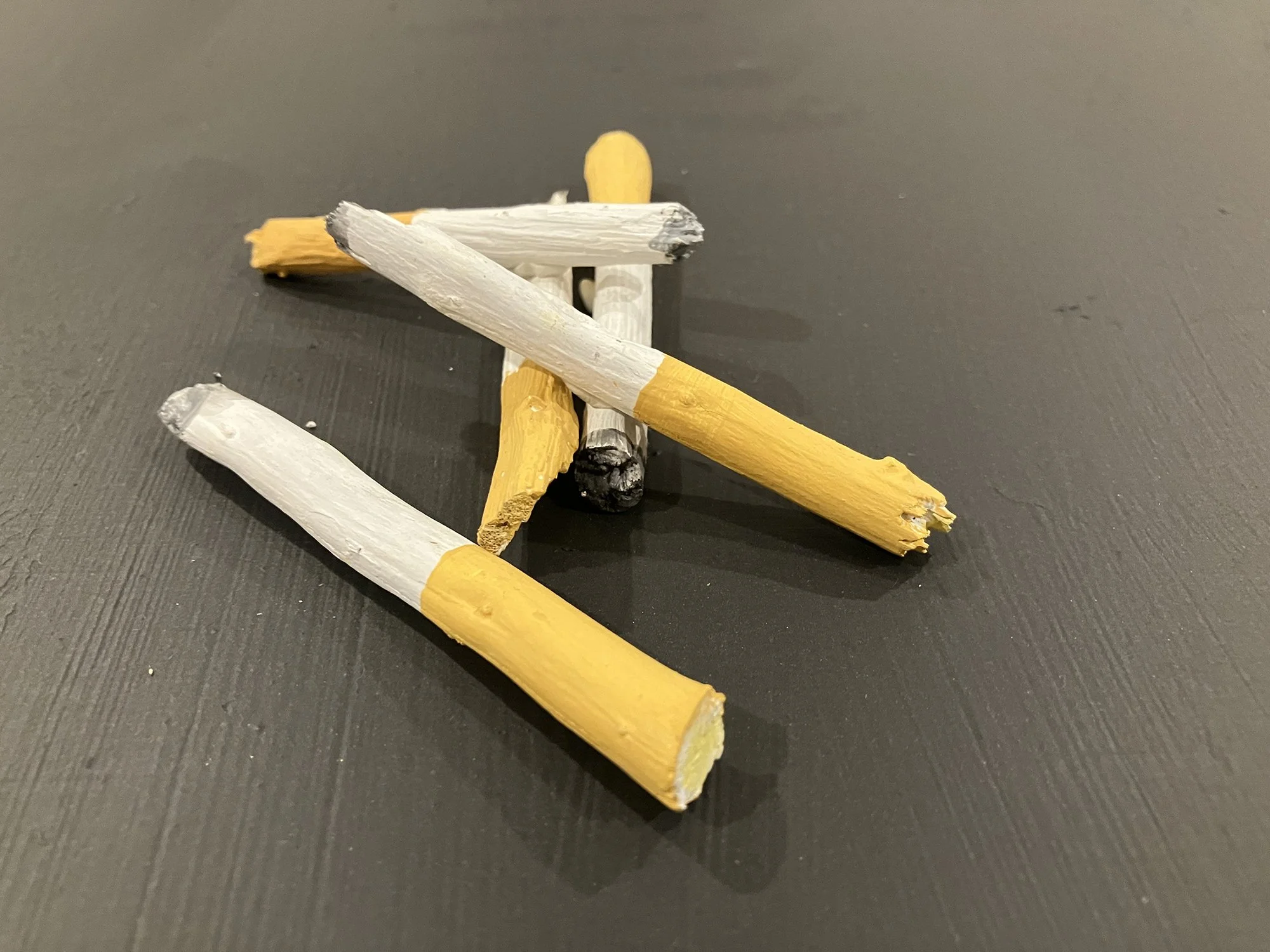 Aaron Frisby,
Cigarette Butts,
2024, paint on wood, 1⁄4 x 3 x 1⁄4” inches each