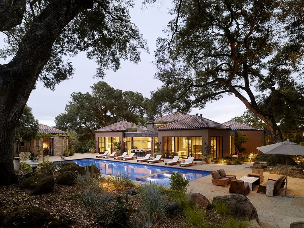a modern concrete patio with a pool