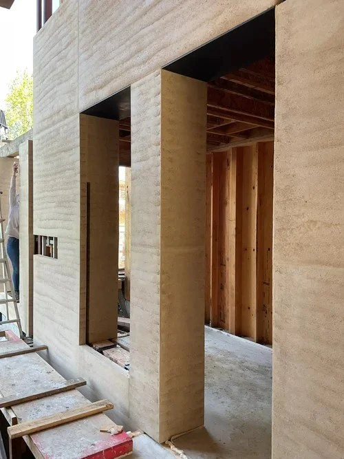 Rammed earth foundation walls on a construction site