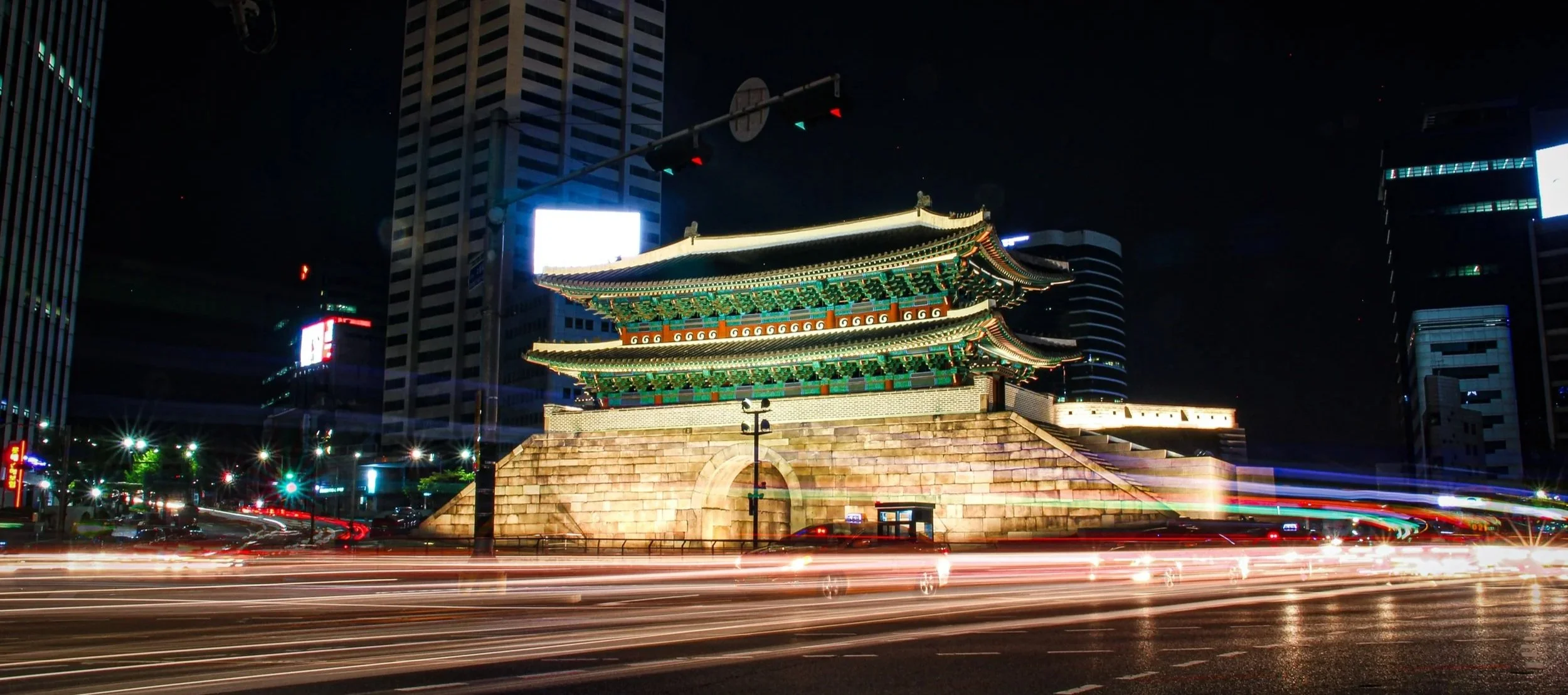 Sungnyemun Gate (Namdaemun) illuminated at night with long exposure car light trails, Seoul, South Korea