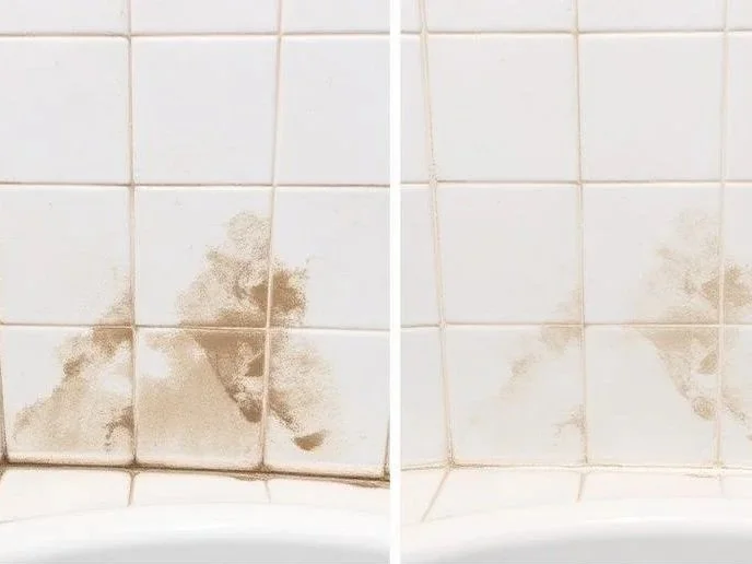 Comparison of two tiled bathroom walls, one stained with mold or dirt, the other cleaned.