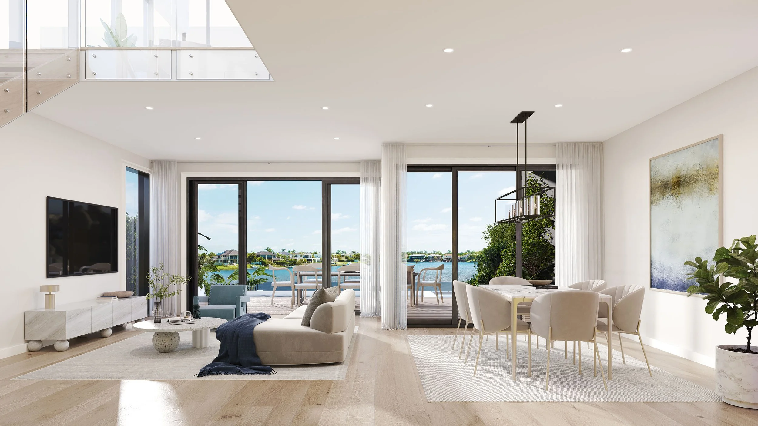 Spacious living and dining area with large glass doors leading to an outdoor patio overlooking water and houses, decorated with modern furniture, plants, and artwork.
