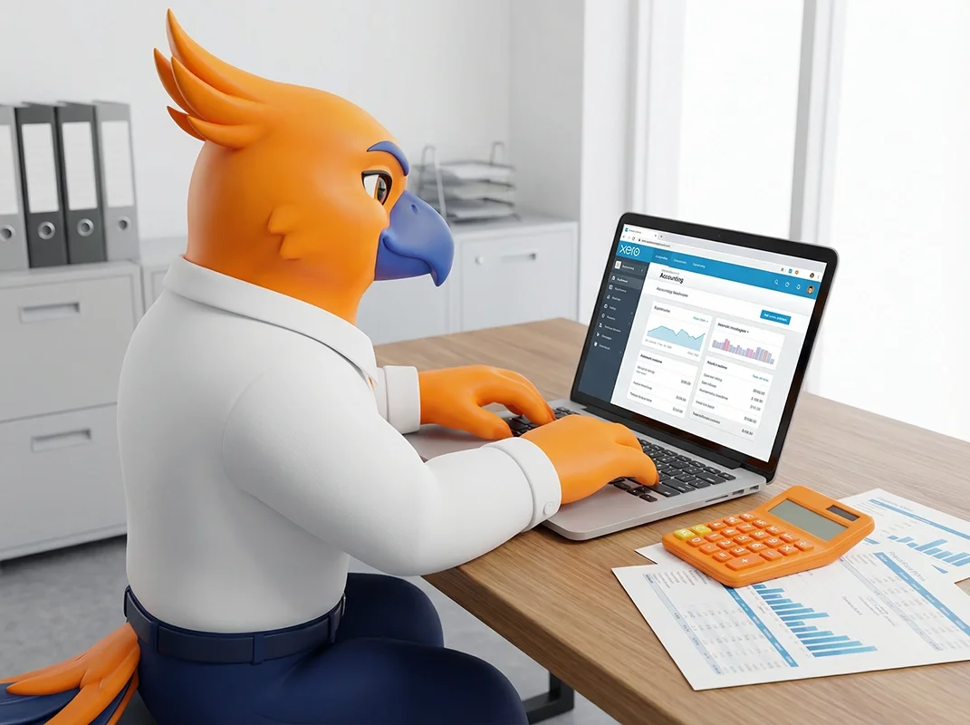 Figurs' Figgy the phoenix mascot with orange feathers, blue beak, and crest, dressed in a white shirt and dark pants, working on a laptop in an office setting with financial documents and calculator on the desk.
