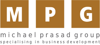 Logo of Michael Prasad Group with brown squares containing white letters M, P, G and text 'michael prasad group specialising in business development' below