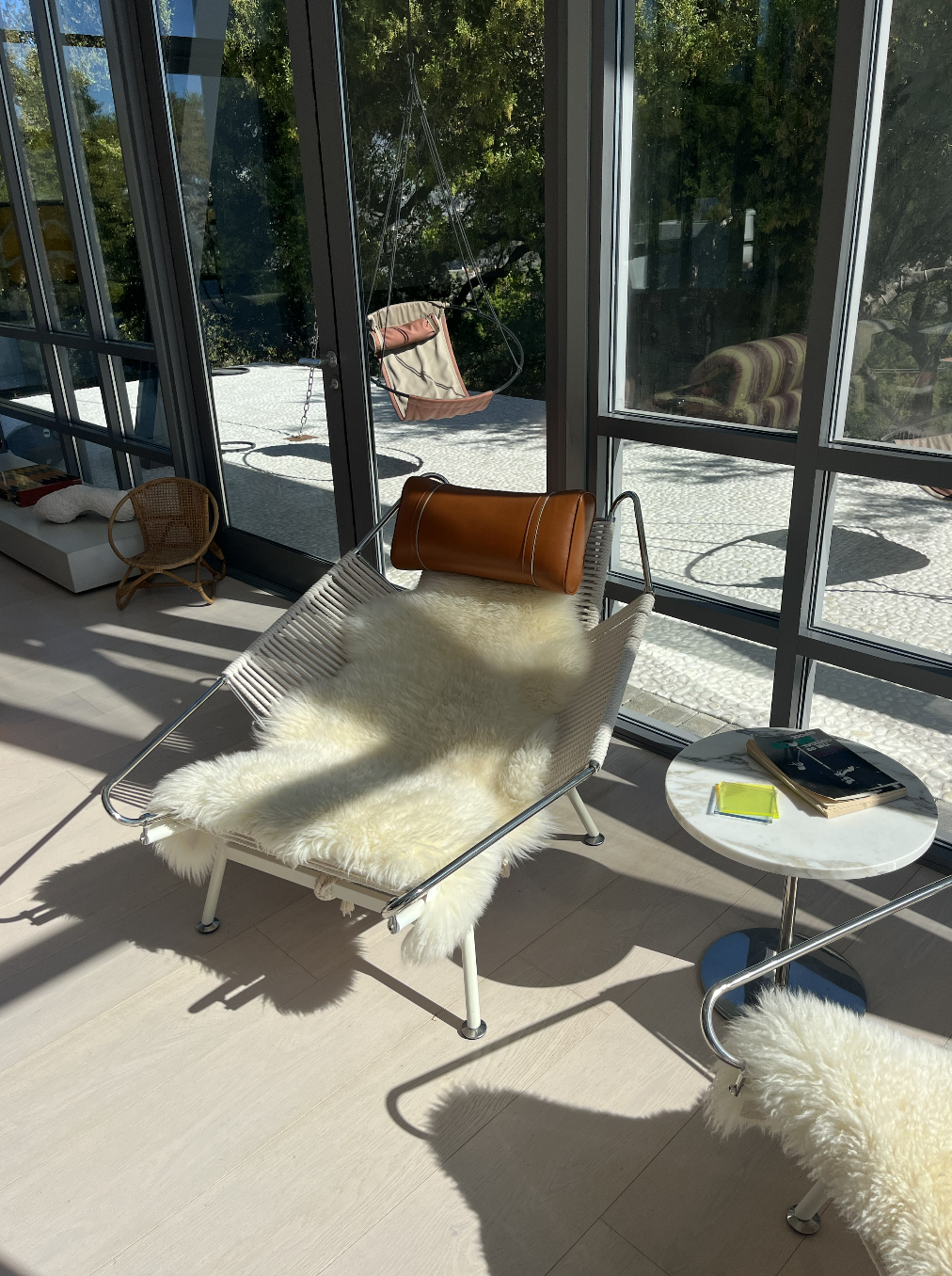 modern chair in front of walls of glass