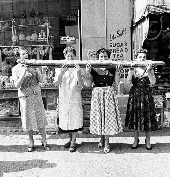 women posing with bread, black and white photo
