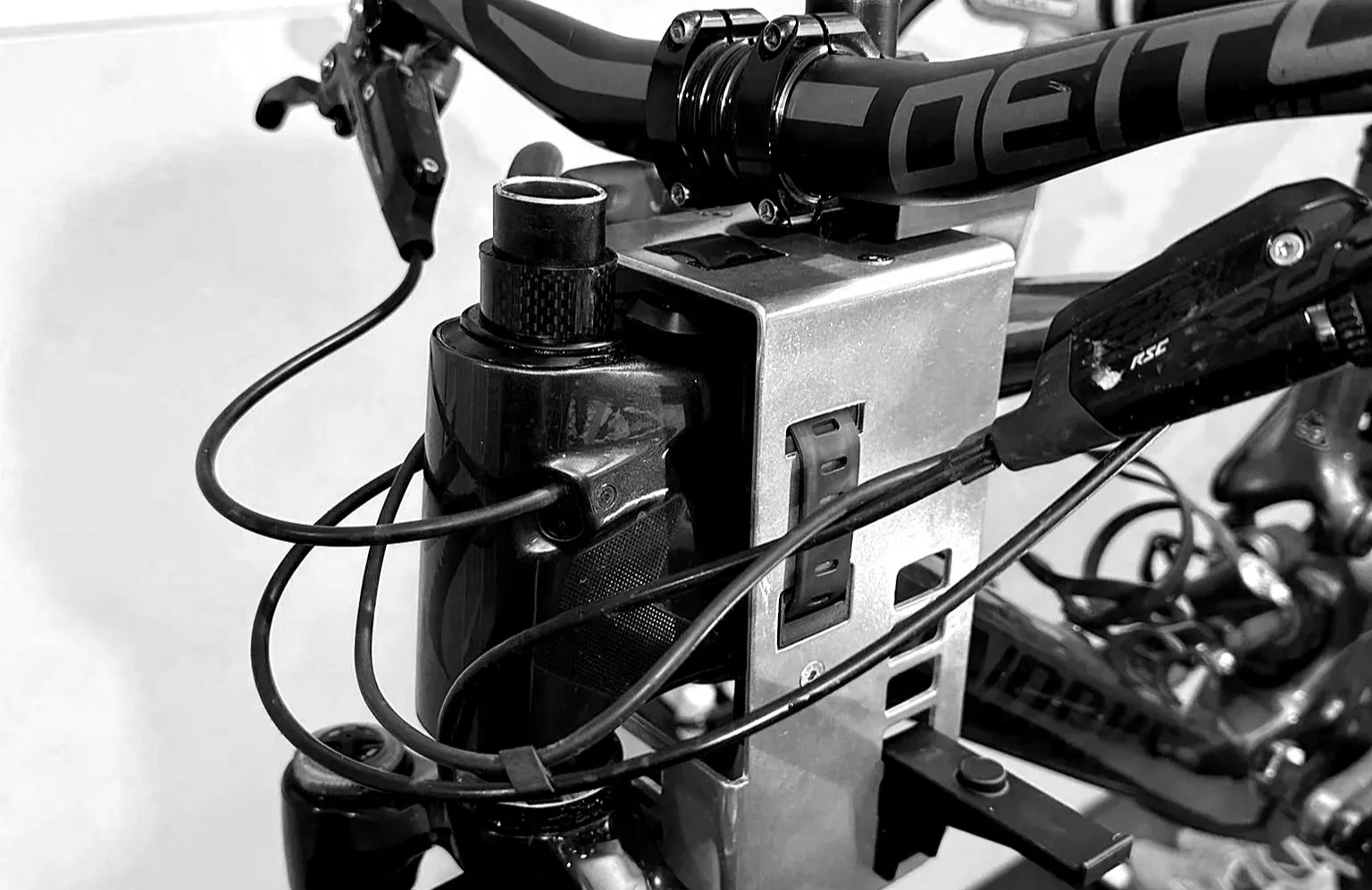 Steering Service Tool mounted on a bicycle frame supporting fork, stem, and handlebars.  Main