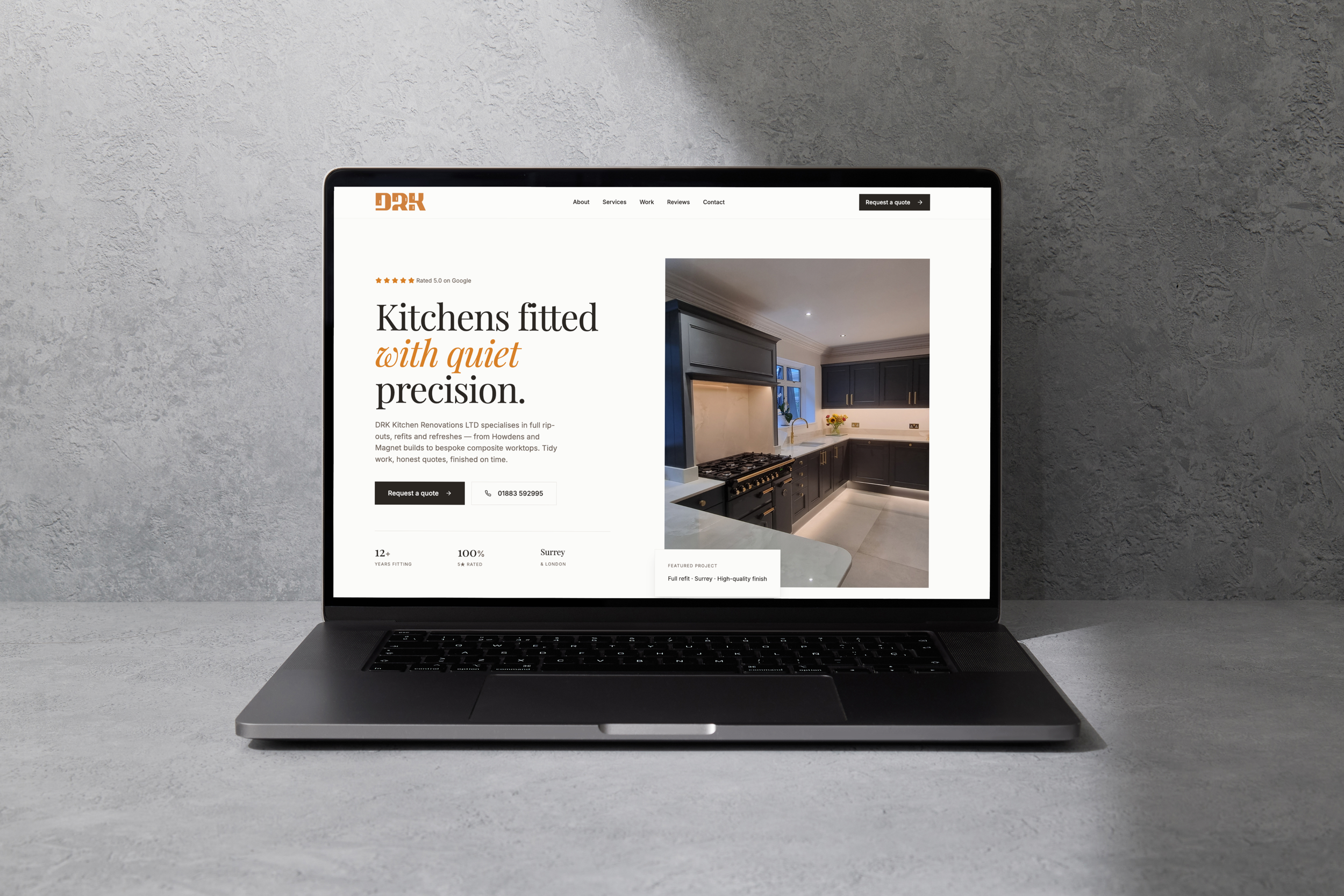 A laptop displaying a website for kitchen renovation services, showing a kitchen image with dark cabinets and a white countertop.