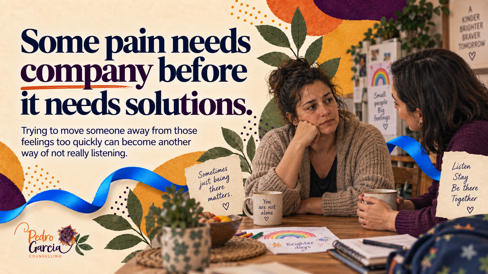 Two women sit together at a kitchen table in conversation, connected by a blue ribbon, illustrating listening and staying present with pain.