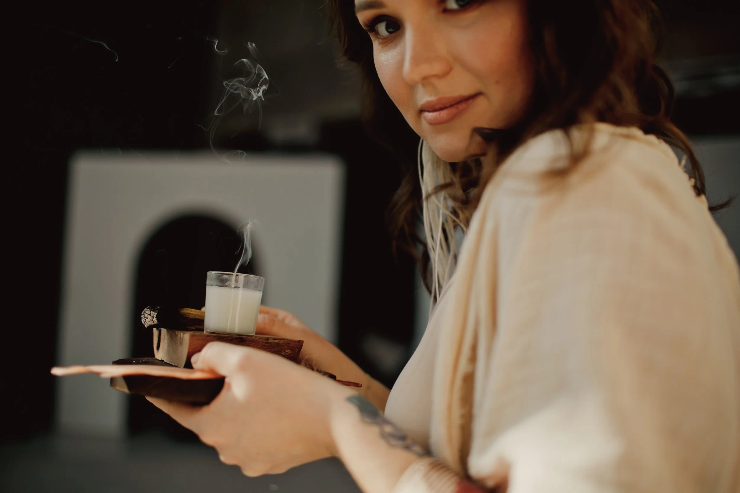 Kathrine holding a cup of tea in a calm, softly lit room – protecting your birth bubble