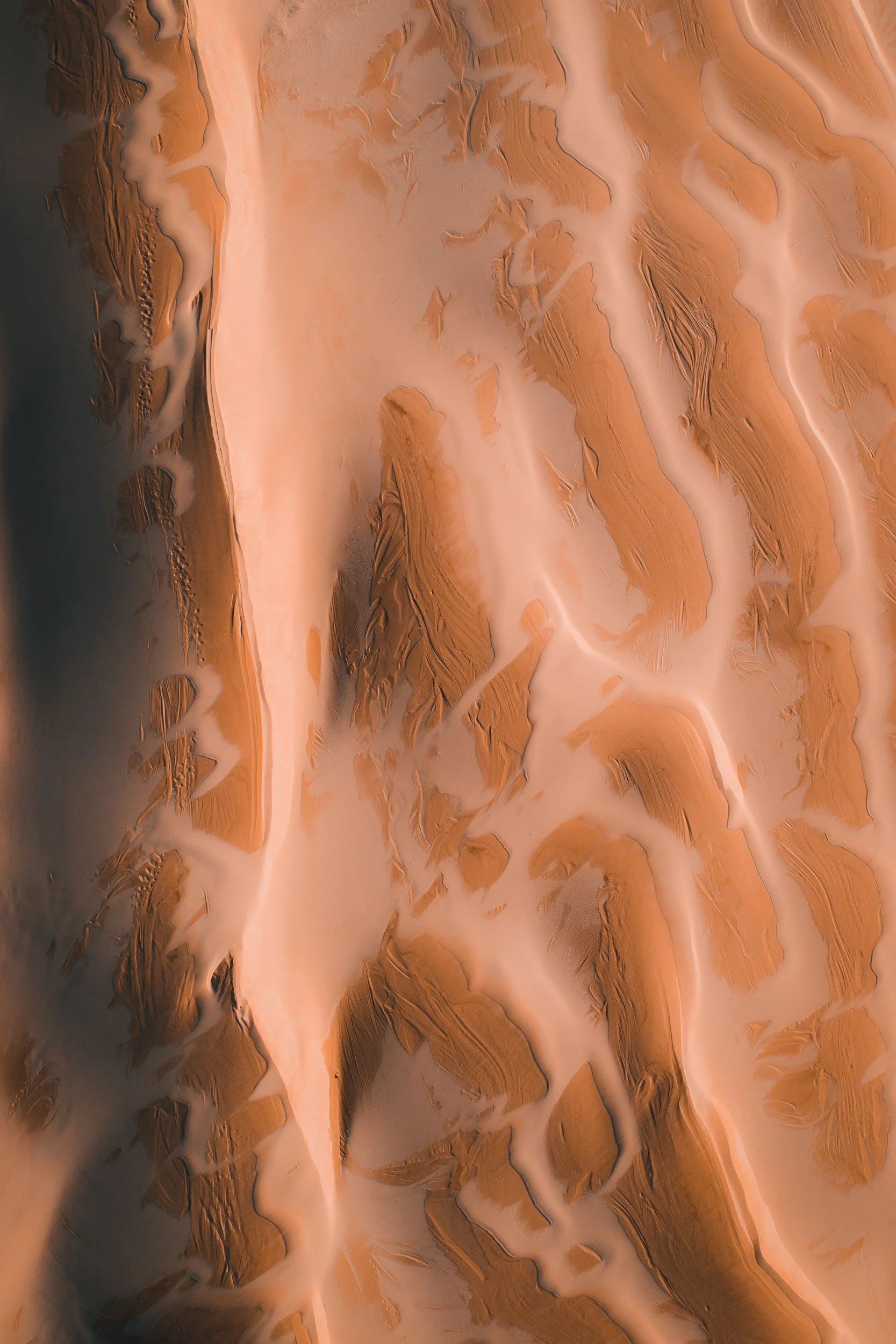 Close-up of a geological terrain with brown and beige layered rock formations and intricate patterns.