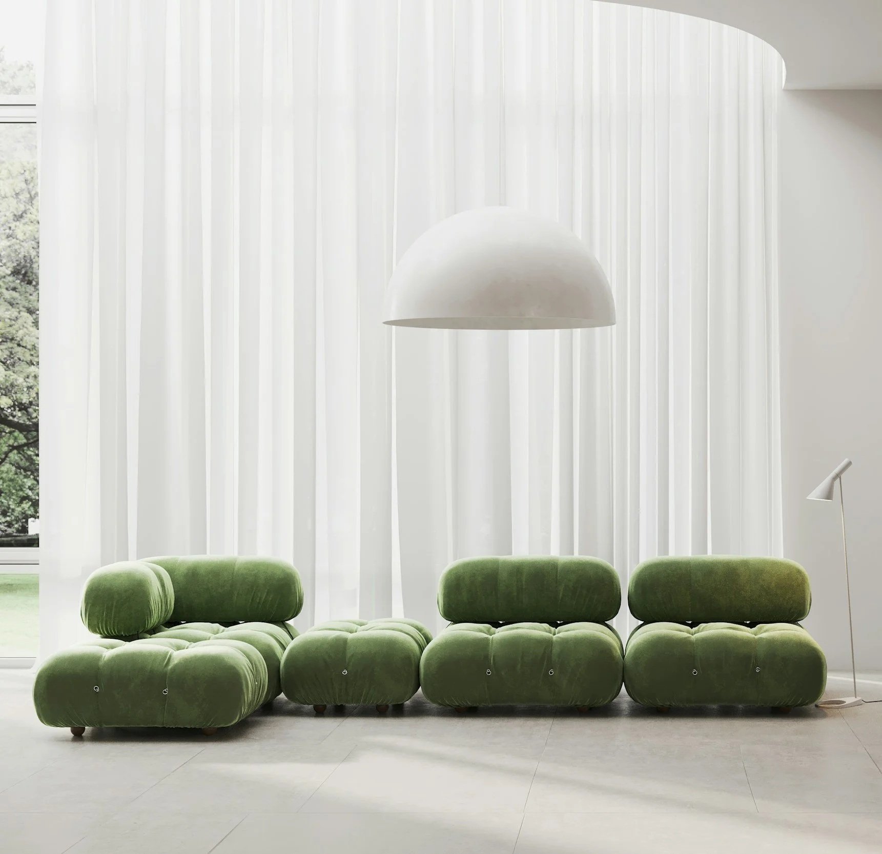 Modern living room with green velvet tufted sofas, large window with white sheer curtains, and white pendant and floor lamps.