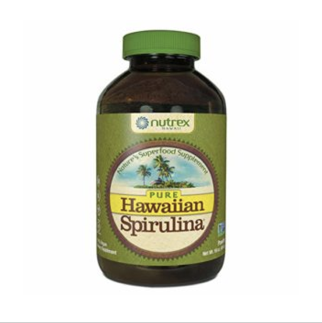 Bottle of Nutrex Hawaii Pure Hawaiian Spirulina dietary supplement with a green cap and label featuring a beach scene with palm trees and blue sky.