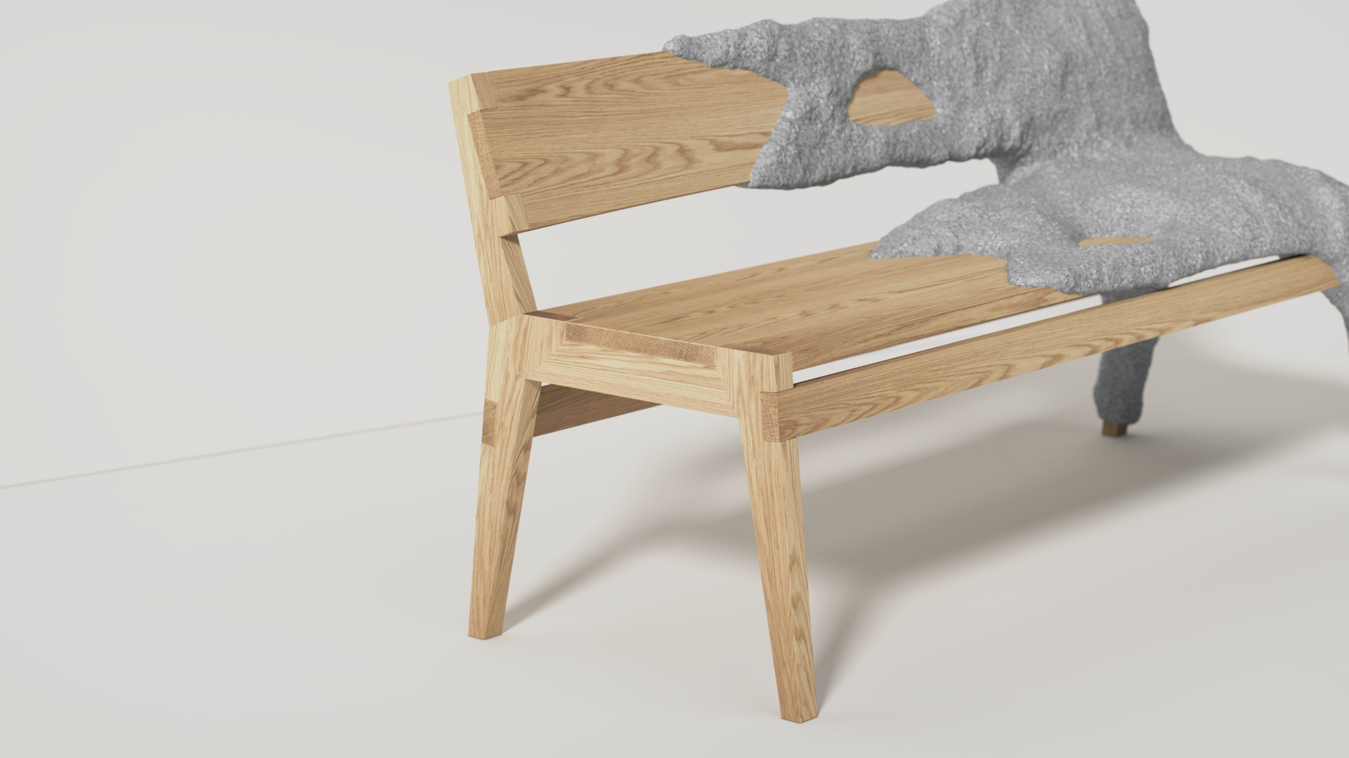 A modern wooden bench with a backrest, featuring a partial concrete sculpture resembling a mountain or abstract form placed on top.