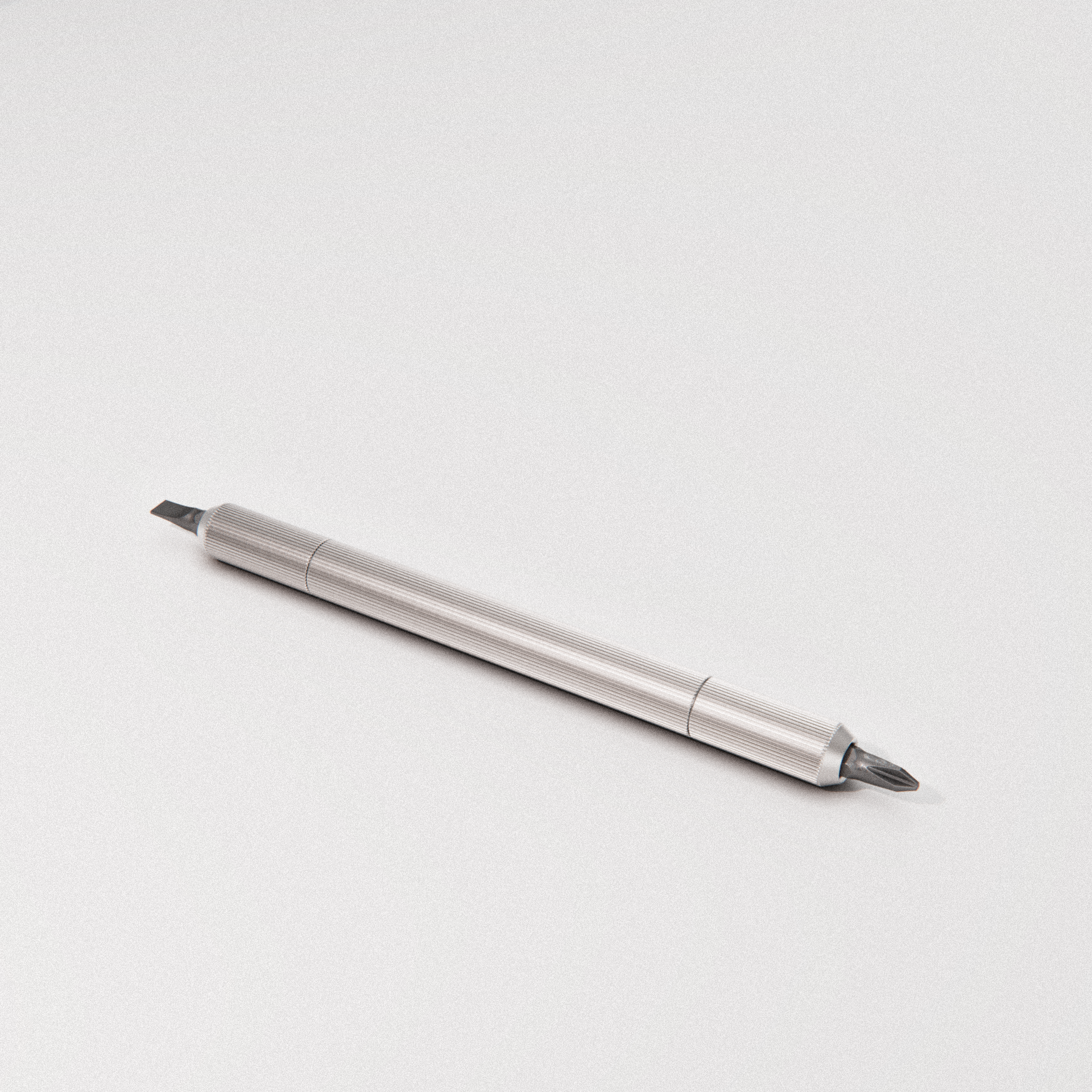 a precision screwdriver with a knurled metallic handle and flat-head tip on a light background.