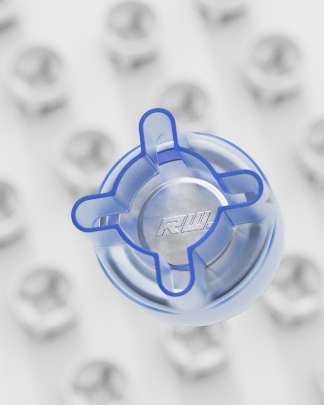 Close-up of a blue and transparent Lego piece on a white background with other Lego pieces out of focus.