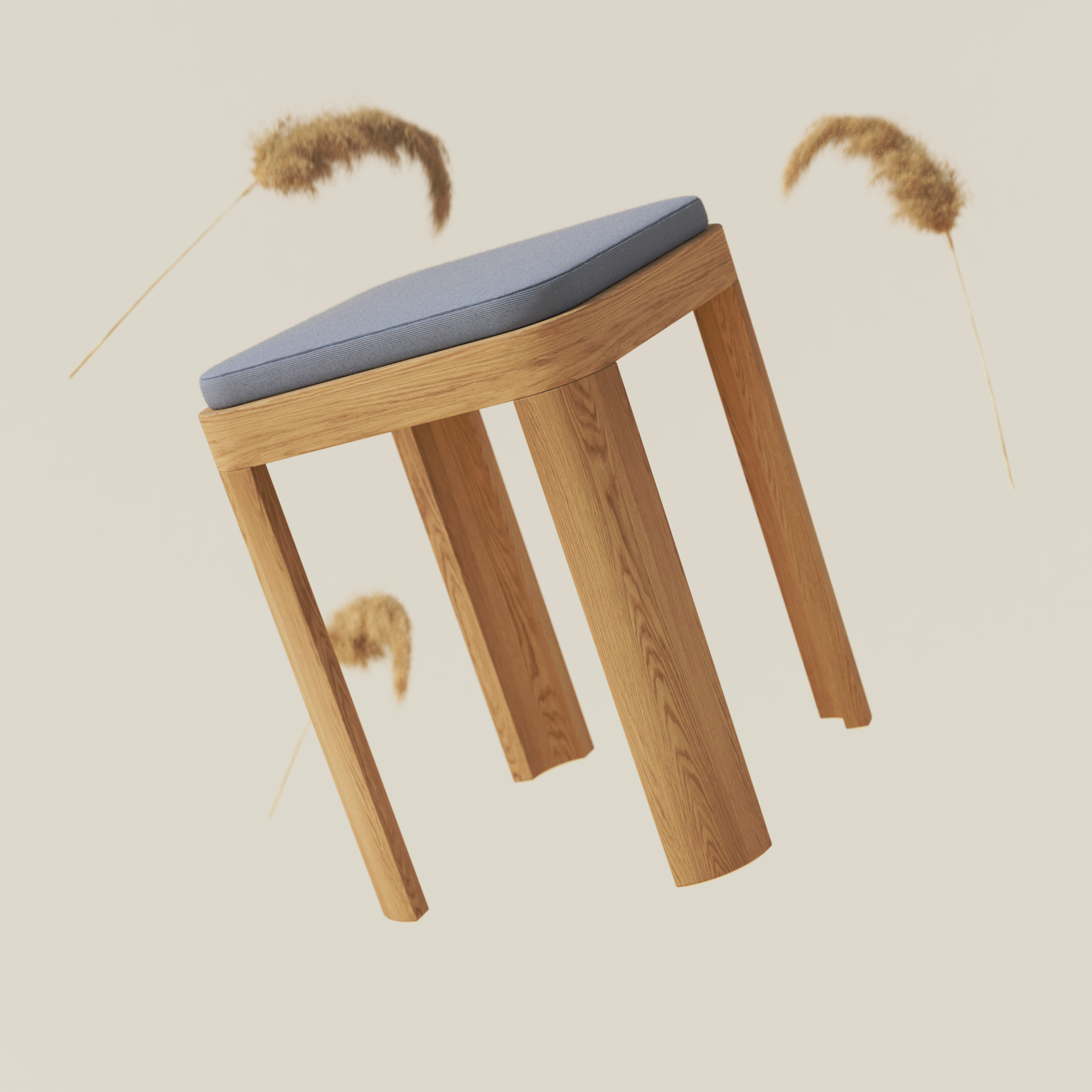 A wooden stool with a padded blue cushion seat, against a neutral background with brown dried grasses.