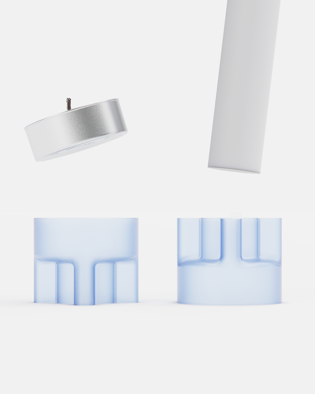 A floating tea light candle with a silver metal container and a wick, above two translucent white cylindrical objects with cut-out sections, all against a plain white background.