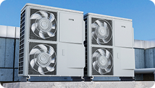 Industrial HVAC units mounted on a building against a blue sky.