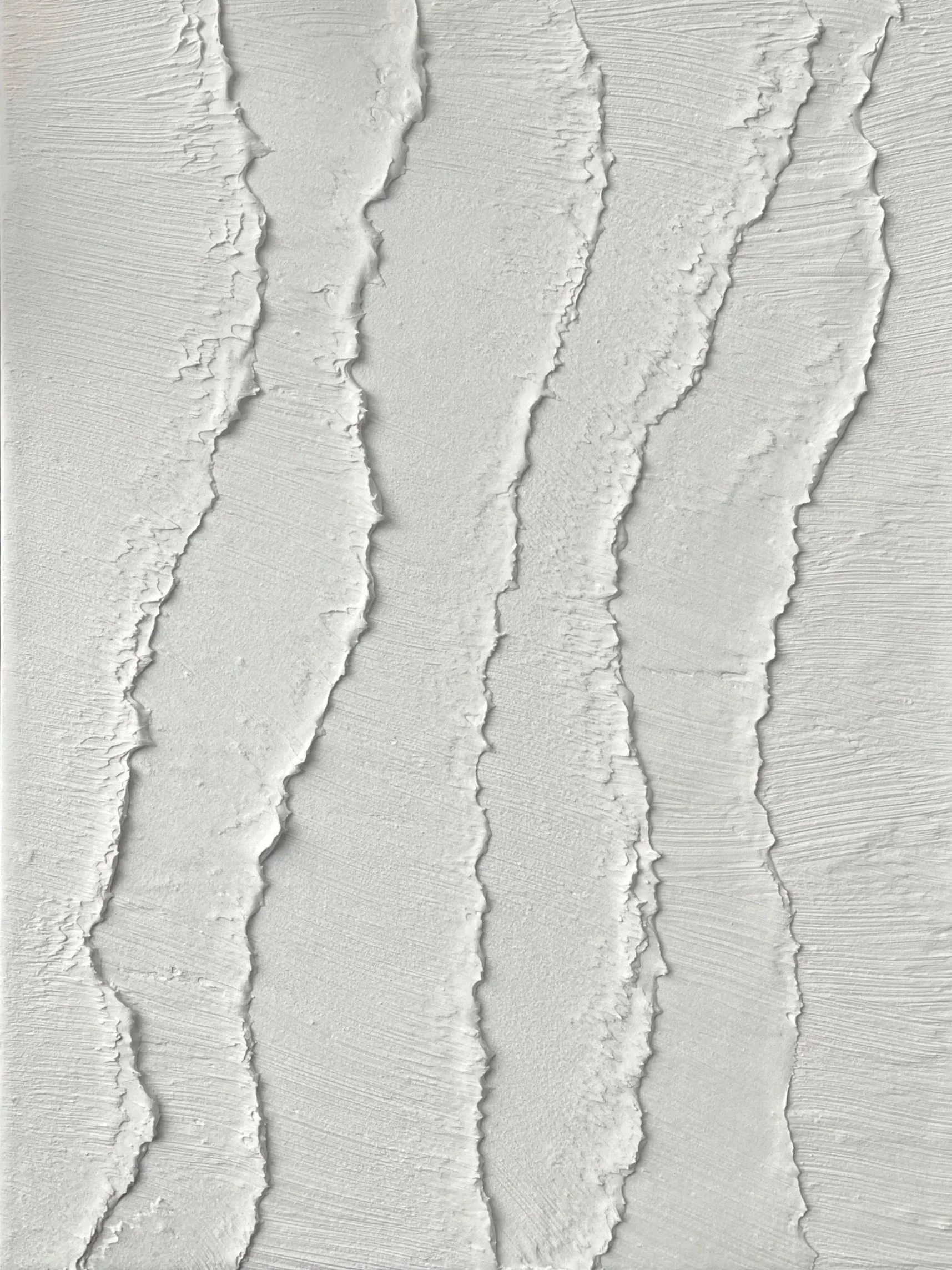 Close-up of textured white paint with visible brushstrokes and ridges.