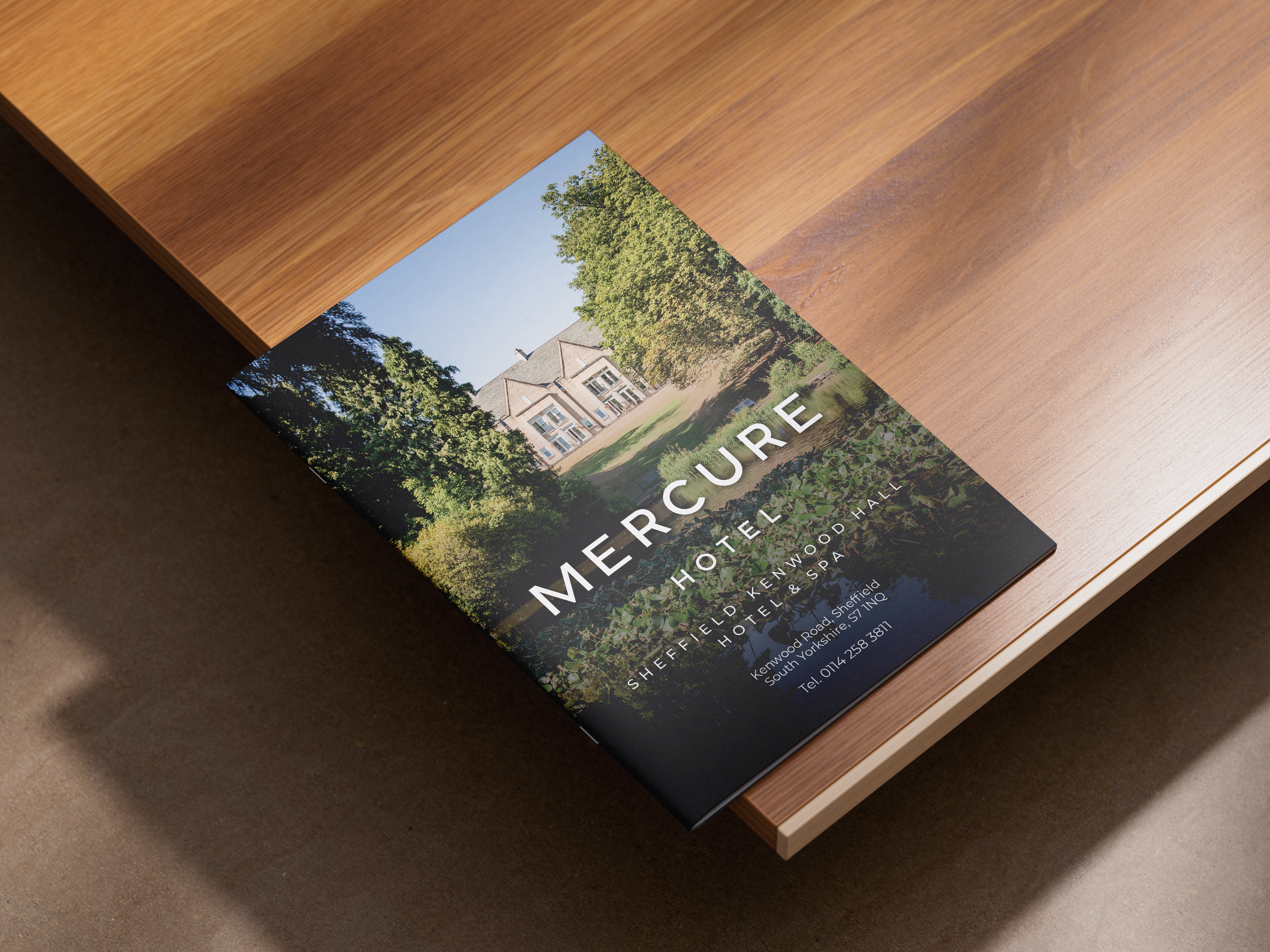 Tourist brochure for Mercure Hotel Sheffield Kenwood Hall & Spa on wooden table.