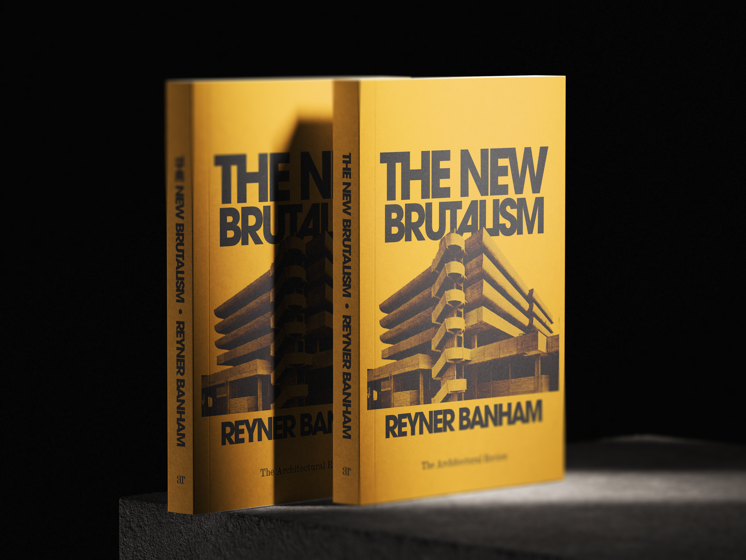 Two yellow books titled 'The New Brutalism' by Reyner Banham, standing upright on a black surface against a dark background, with a building architectural illustration on the cover.