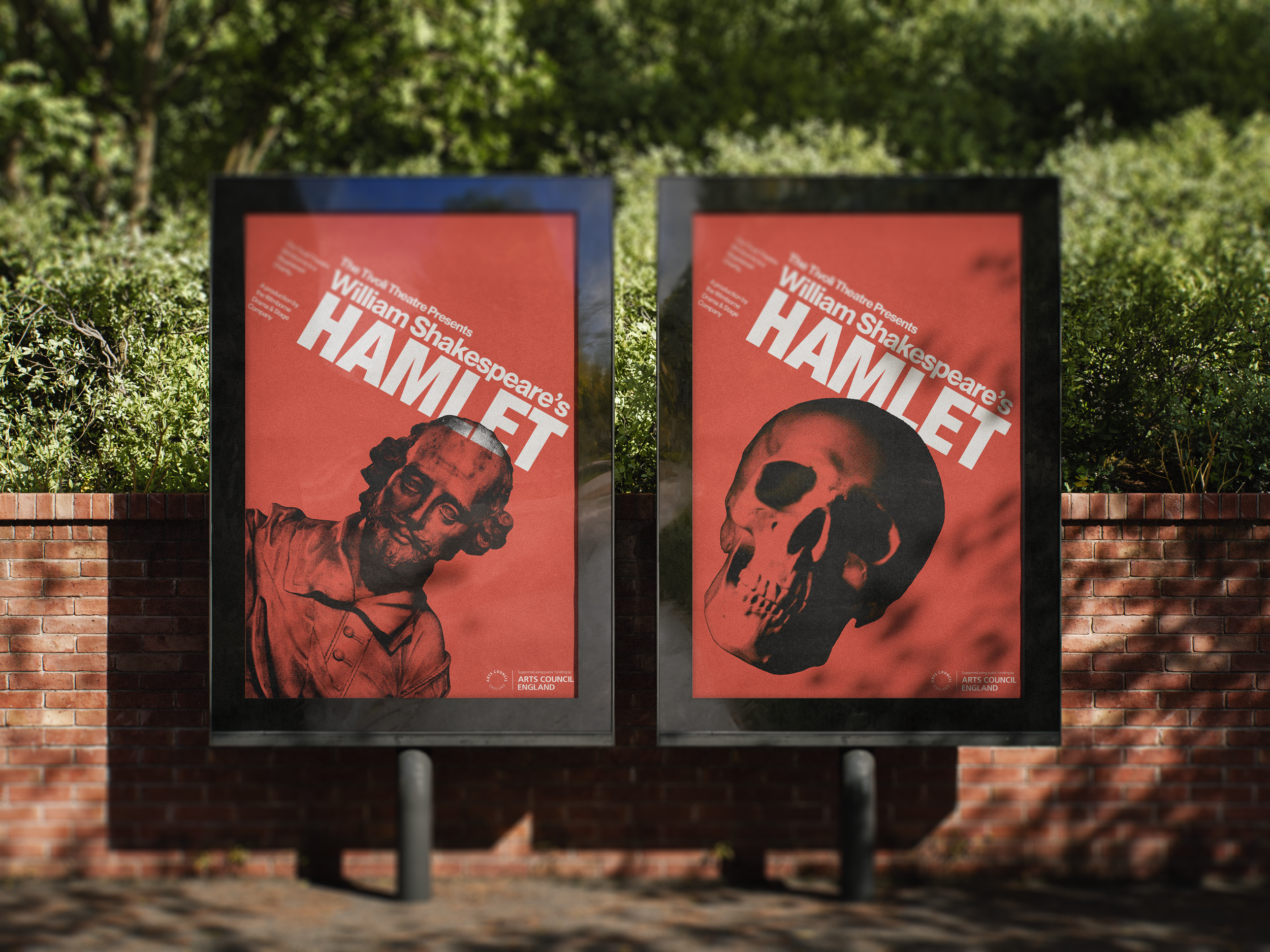 Two posters advertising a Shakespeare play titled 'Hamlet,' featuring a carved skull and the face of a man with a beard and glasses, displayed outdoors against a brick wall and greenery.