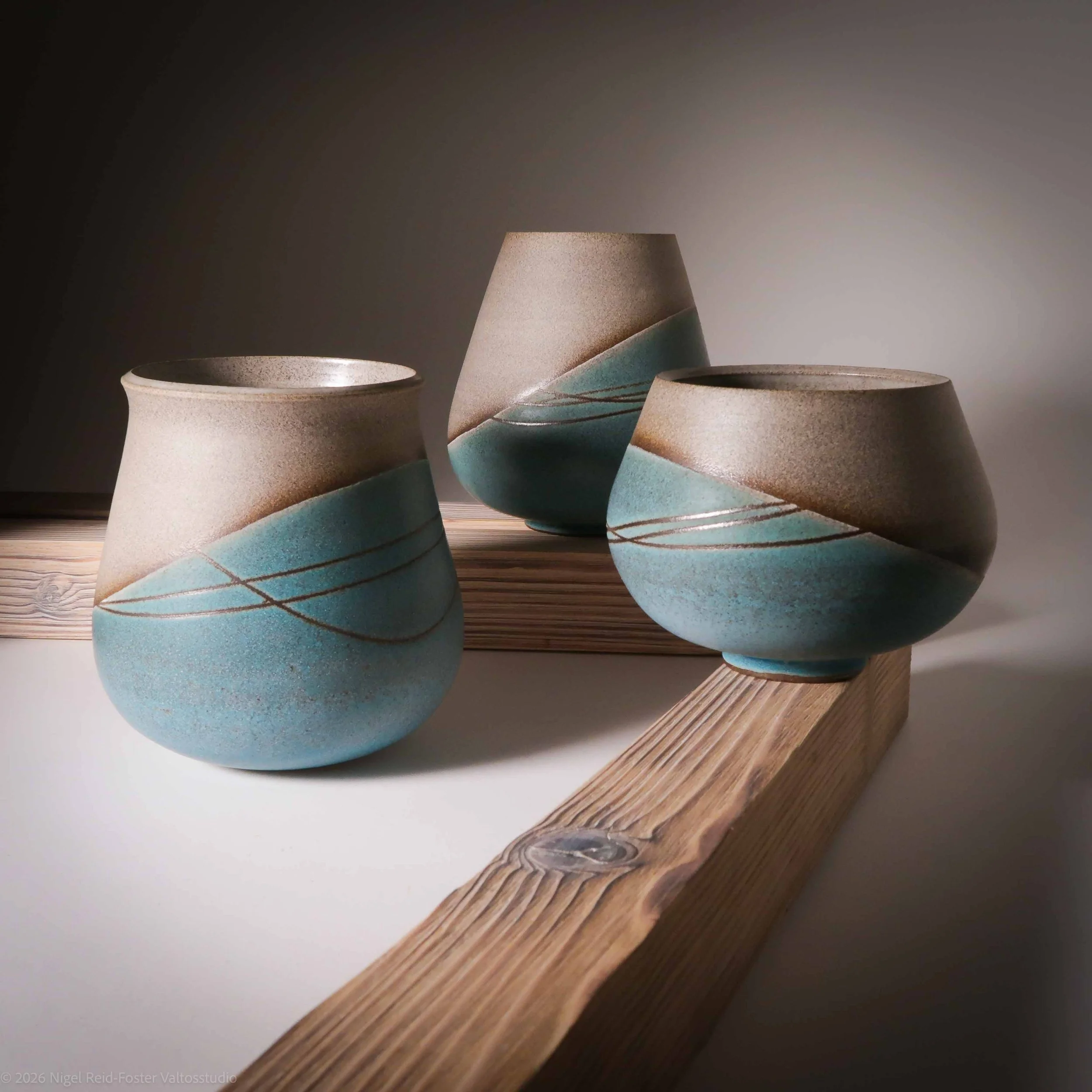 Grant grey medium sized oval forms (3) with turquoise satin glaze over the lower half incised with simple sgraffito lines