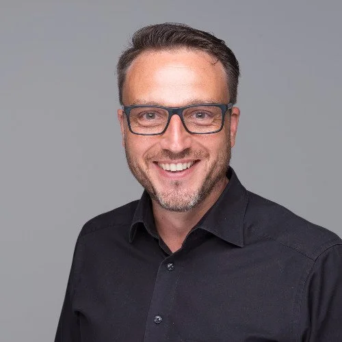 professional headshot of man smiling