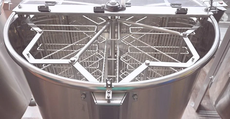A large industrial ice cream or gelato maker with metal racks inside for freezing