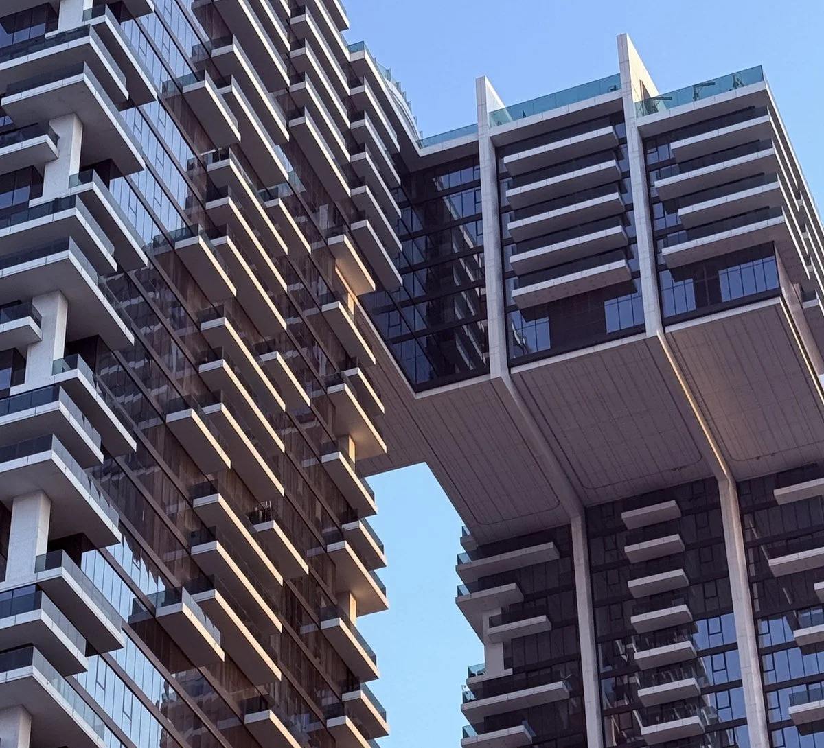 Balconies of a modern residential tower in Dubai, typical of off-plan apartment developments
