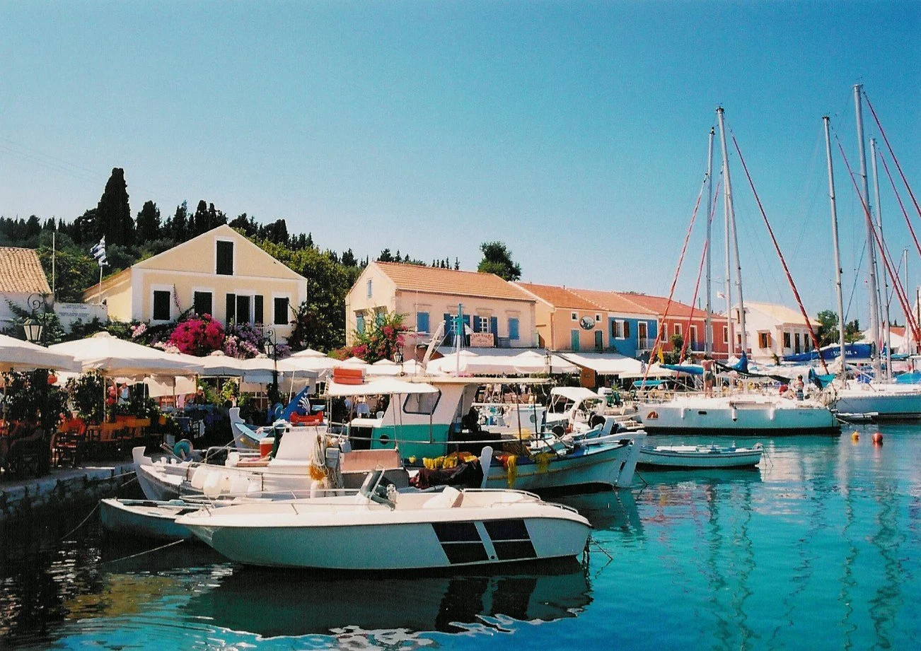 Cosmopolitan harbor of Fiskardo, Kefalonia, reached by private boat transfer from Ithaca. Exploring the Venetian streets of Fiskardo during a luxury private boat day trip from Frikes port.