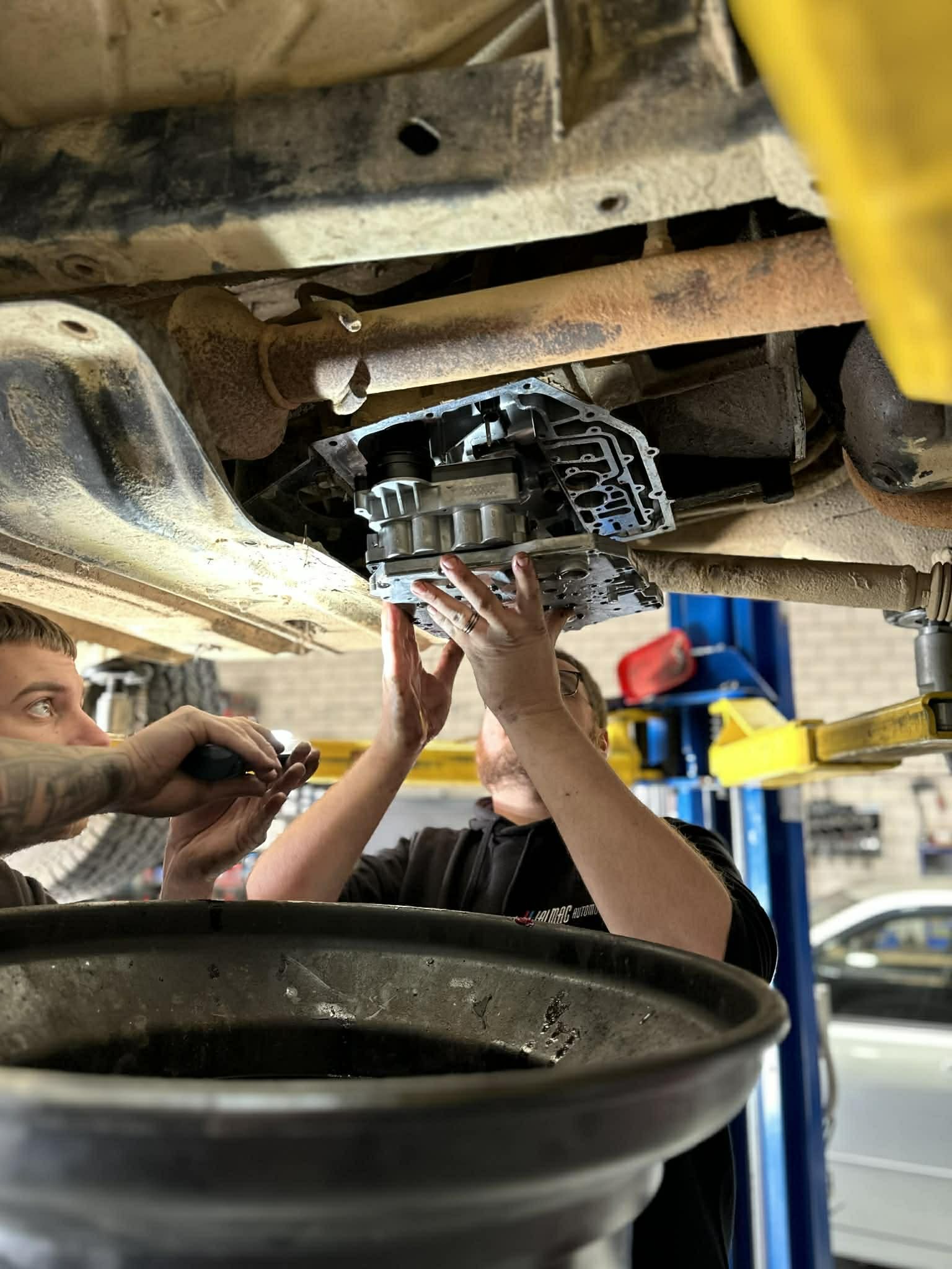 Mechanic inspecting a vehicle for transmission repairs at Jalmac Automotive in Ringwood