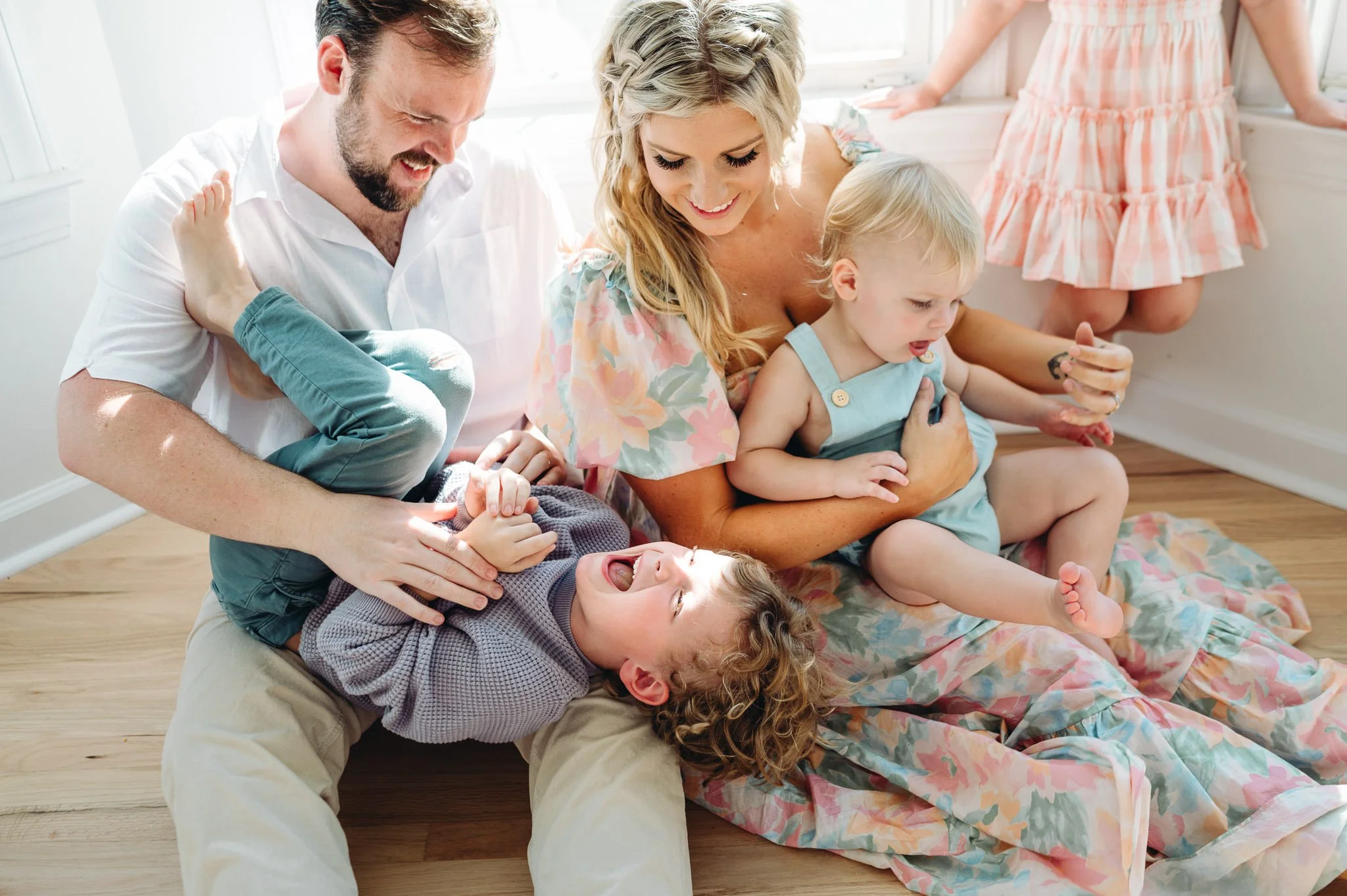 parents tickle their children, relaxed family photograph in Bend, Oregon