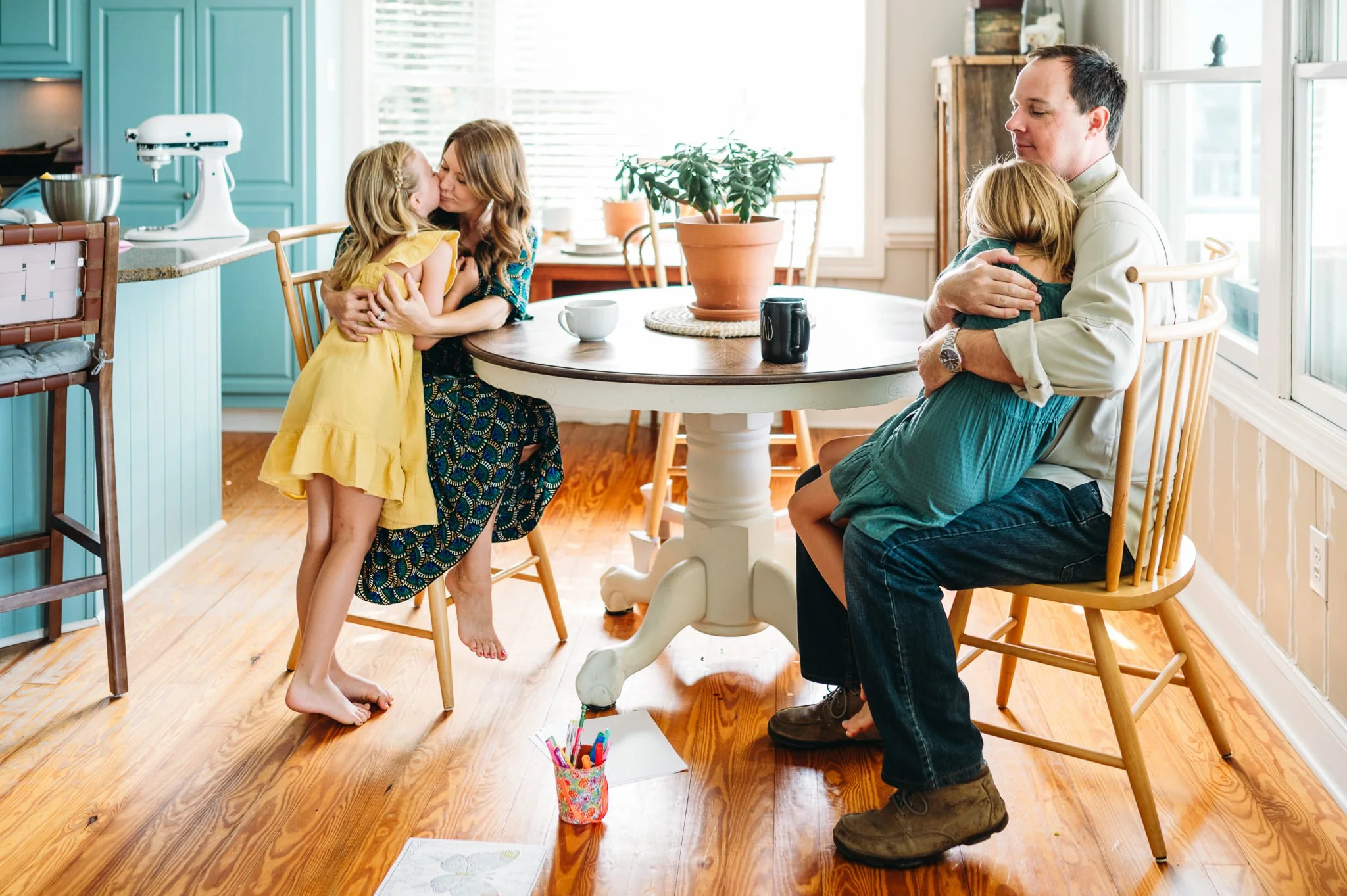 Parents hugging their daughters in a relaxed, connected family photo session in Bend, Oregon