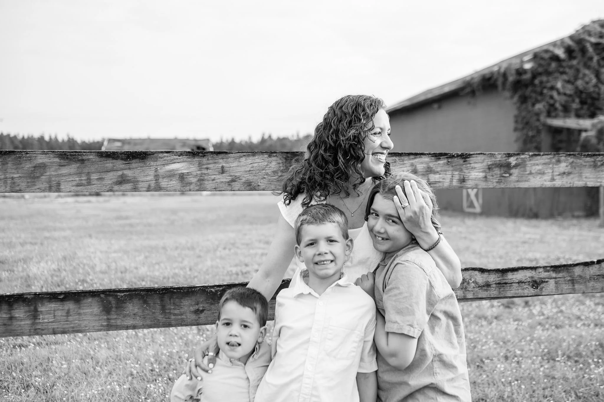 mother with three boys standing along a fence in Central Oregon, by Elise Souders, photographer