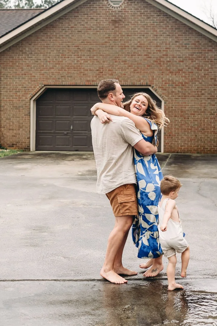 Family portraits in Bend, Oregon of dancing playfully in their driveway, by Elise Souders, photographer