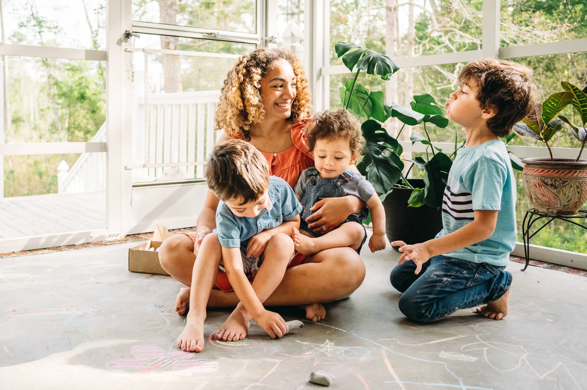 a mother and three sons laughing while drawing, motherhood photoshoot Bend, Oregon