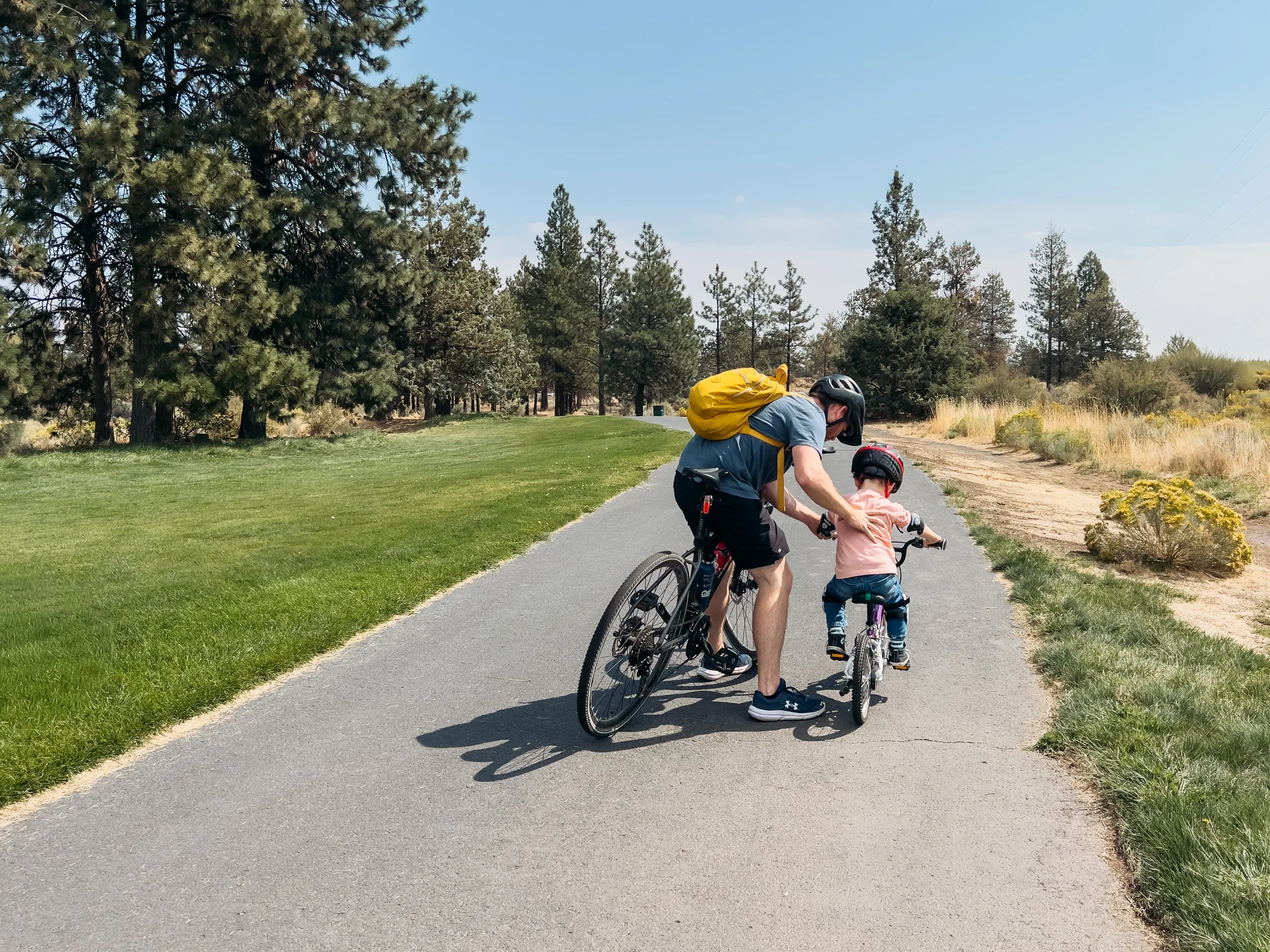 Stroller friendly trail walk through Pine Nursery Park in Bend, Oregon with family members biking along, by Elise Souders, photographer