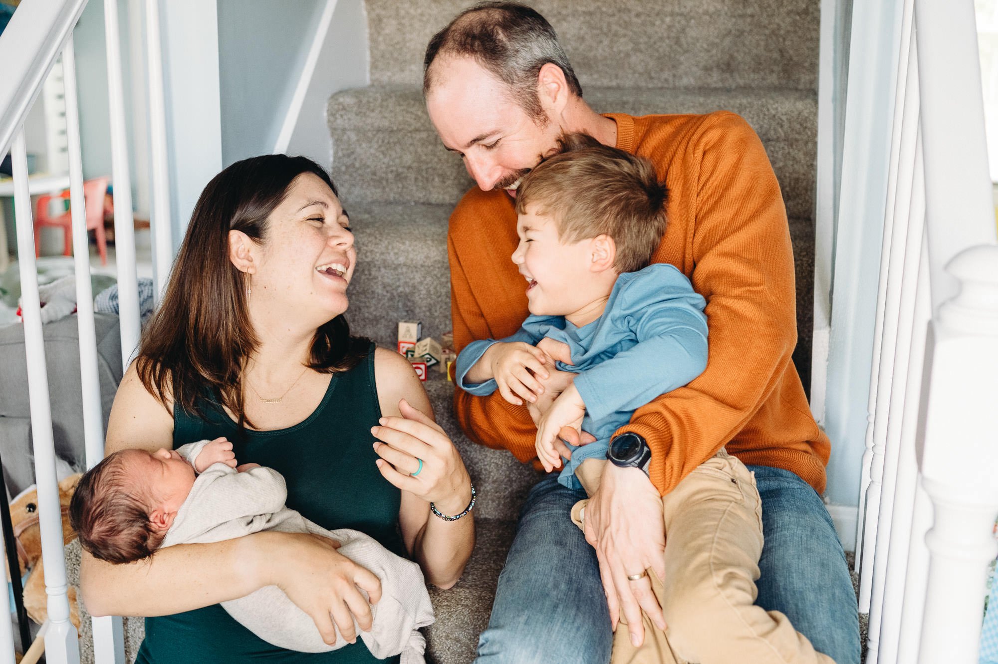 Family laughing together with toddler and newborn baby, newborn photos by Elise Souders