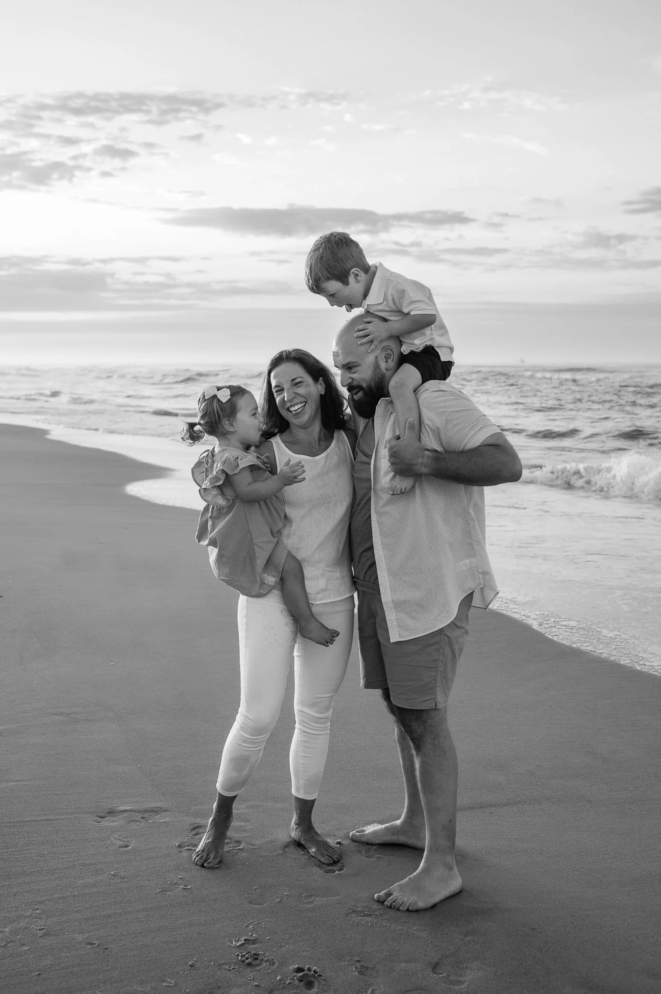 Parents holding children, laughing for natural family photos in Oregon, by Elise Souders, photographer.