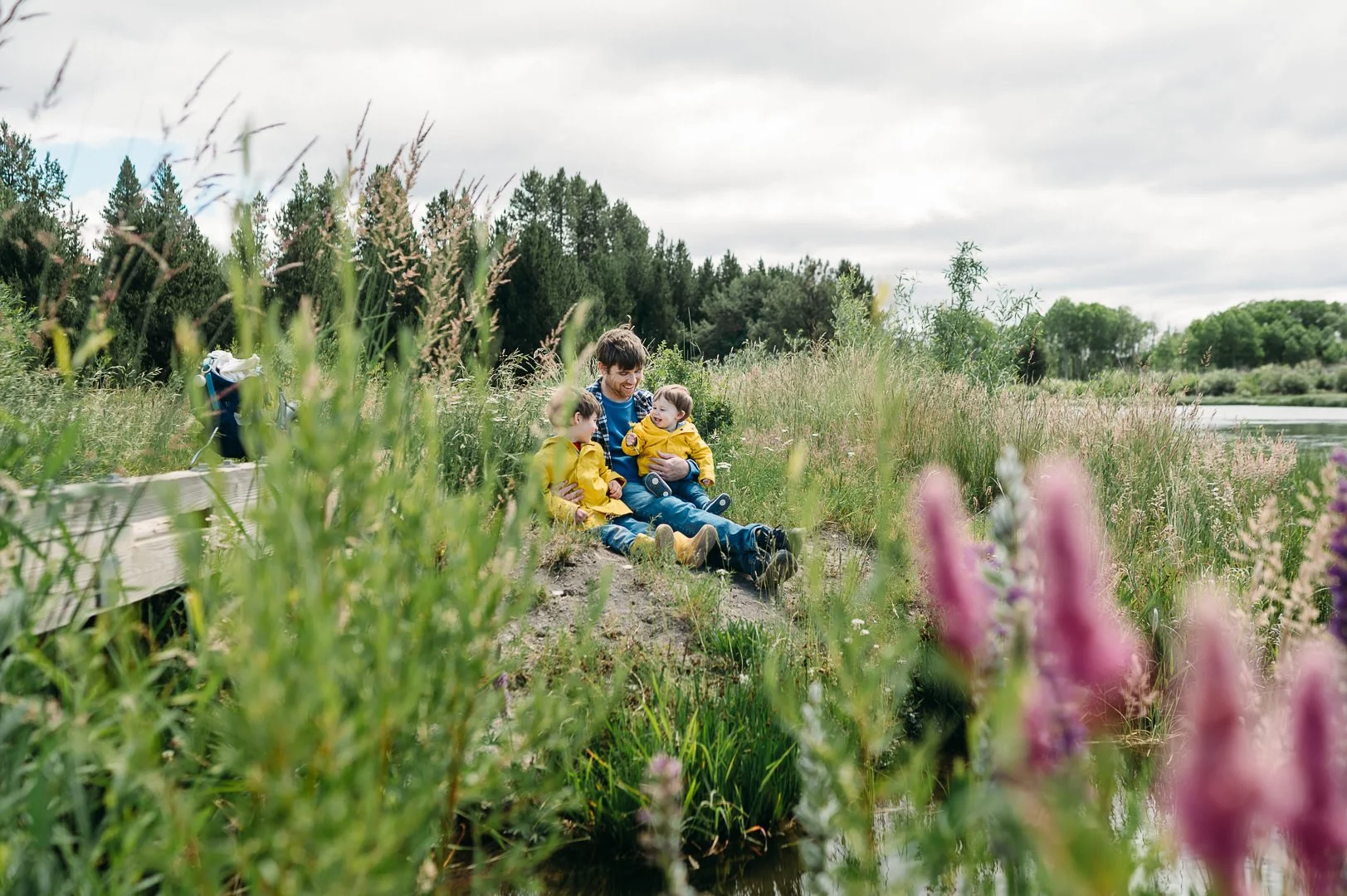 Father and two sons resting during a kid friendly hike near Bend, Oregon at the Deschutes River by Dillon Falls, by Elise Souders, Photographer
