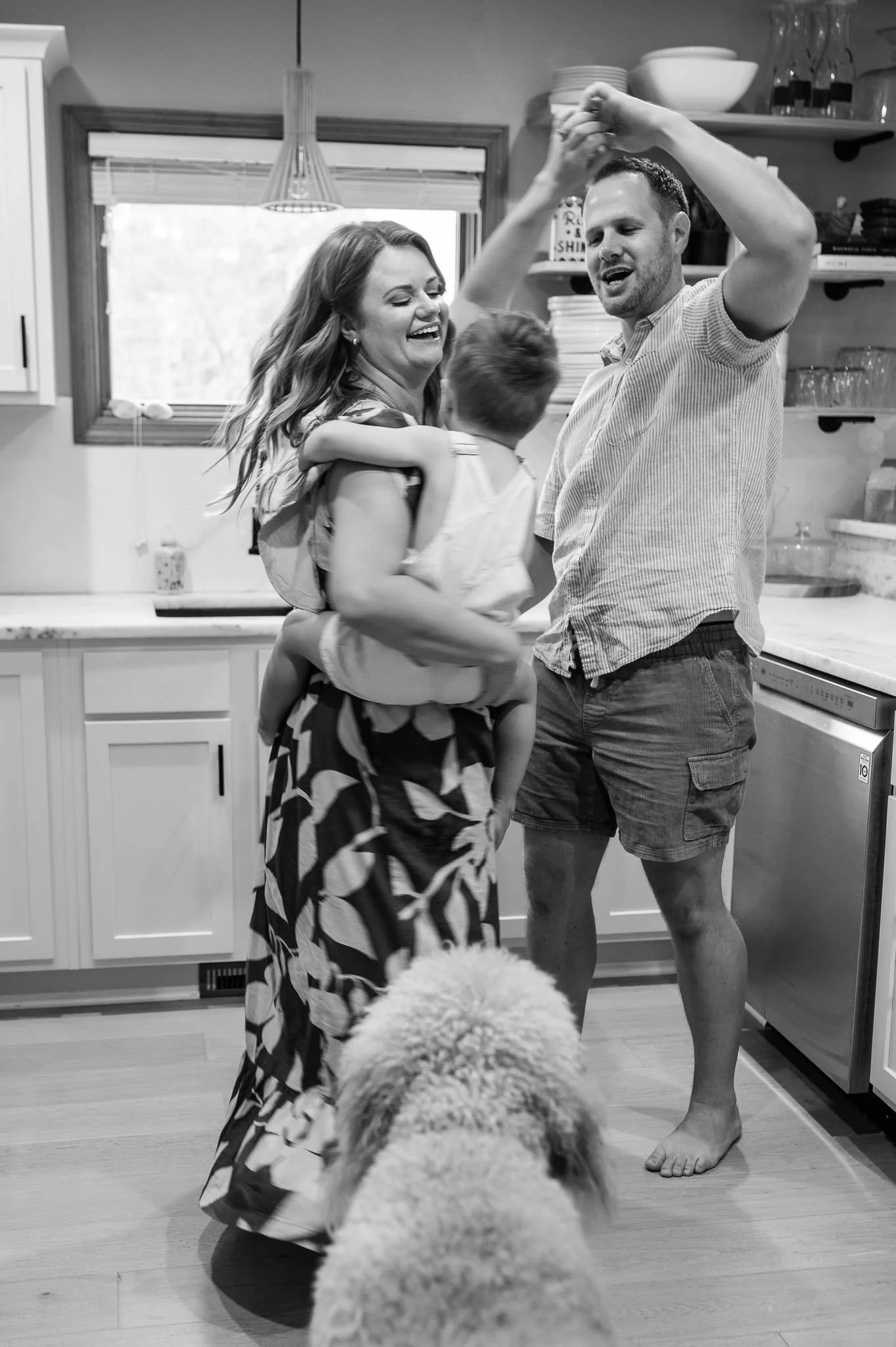 family dances together in their kitchen, candid family photographer in Bend, Oregon