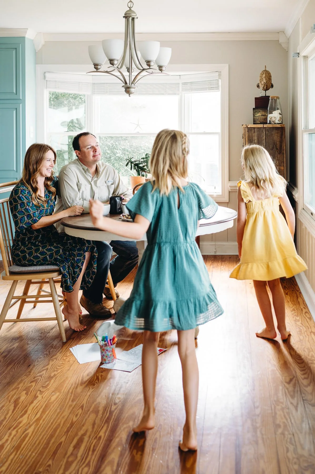Girls running towards their parents at breakfast, family photograph by Elise Souders, Bend Family Photographer