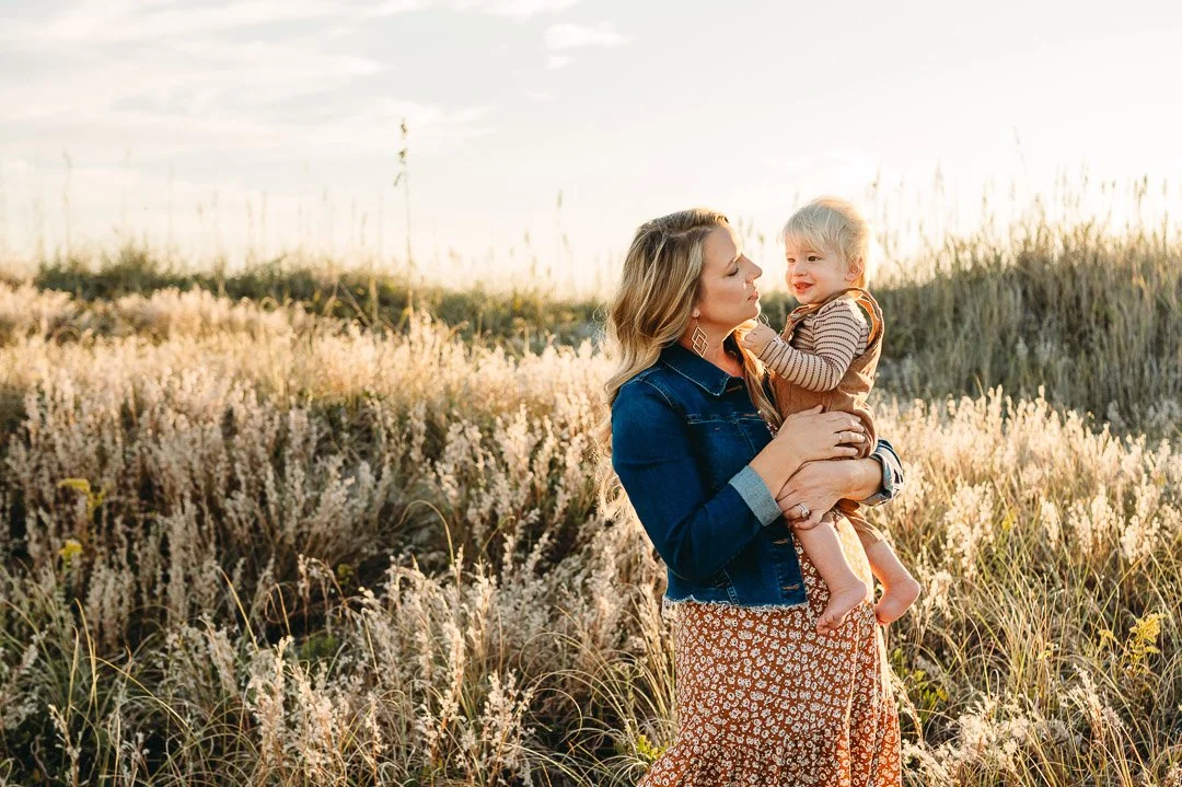 Jean jacket layered over outfit and overalls for family photos in the fall in Bend, Oregon