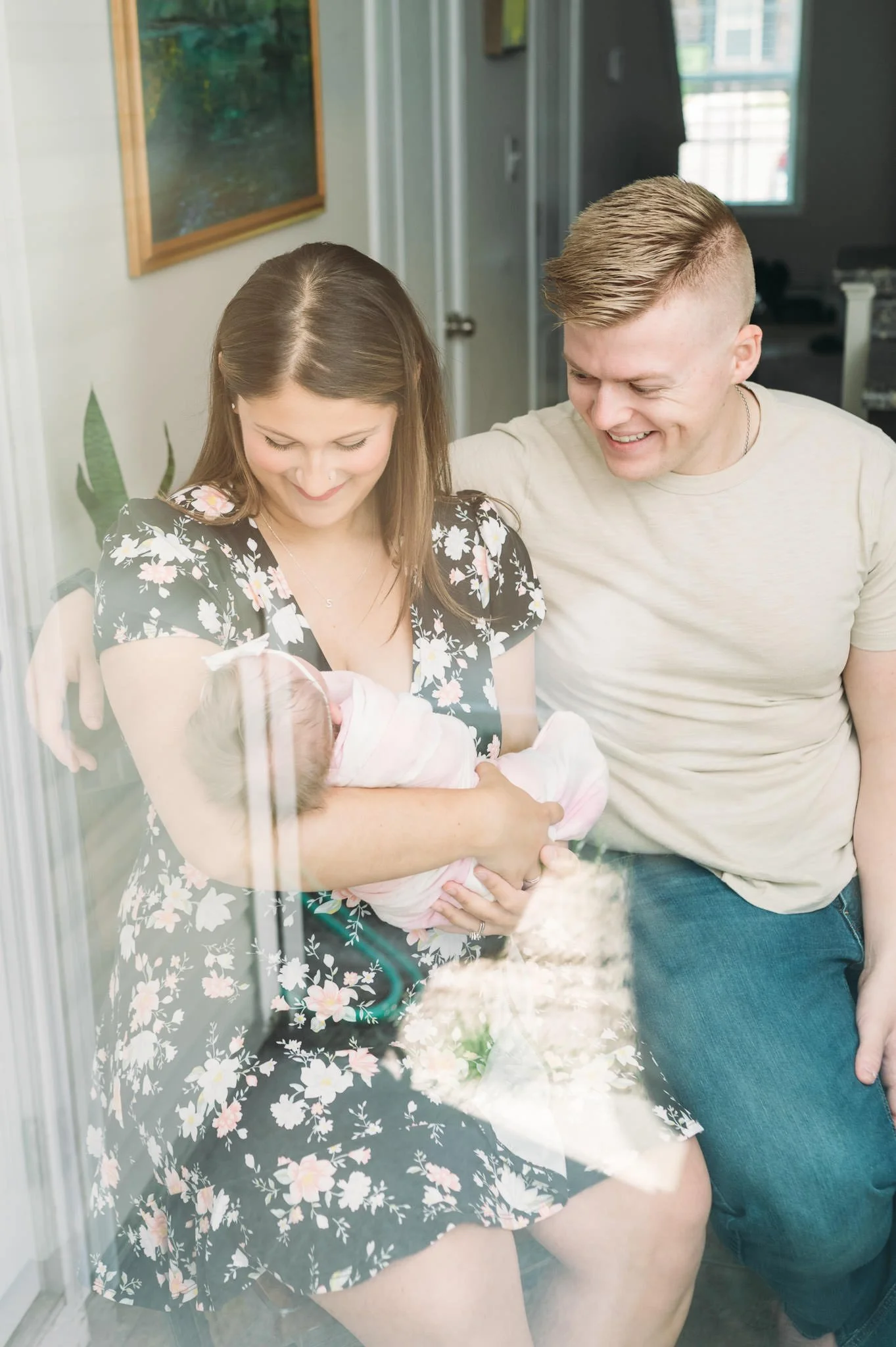 New mother and father looking at newborn baby girl, Bend, Oregon in-home newborn session by Elise Souders, photographer