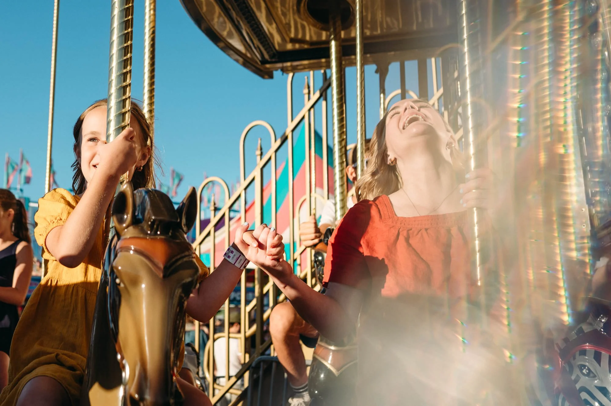 Mother and daughter having fun at the Deschutes County Fair in a candid portrait, by Elise Souders.